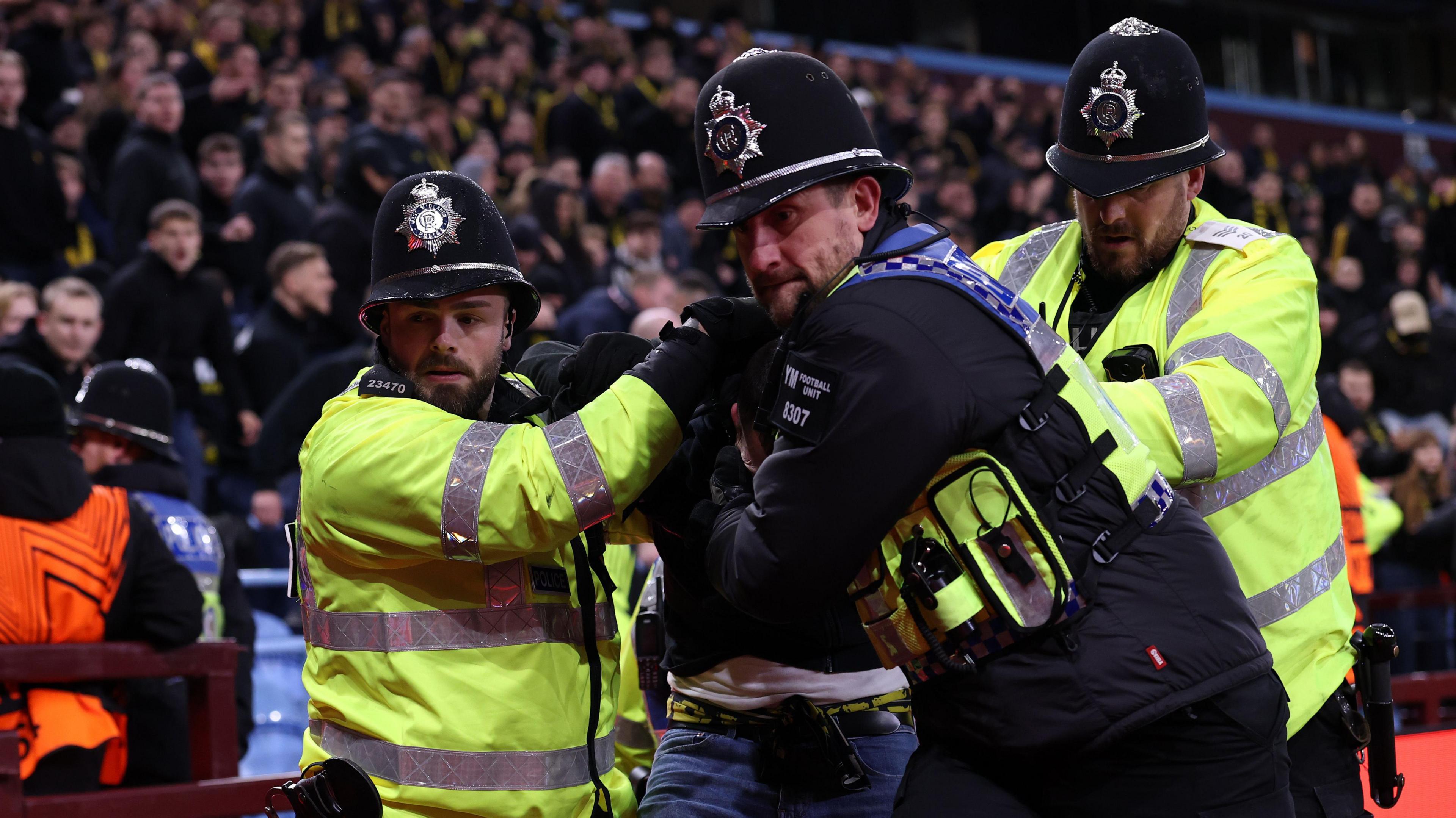Police escort a Young Boys fan 