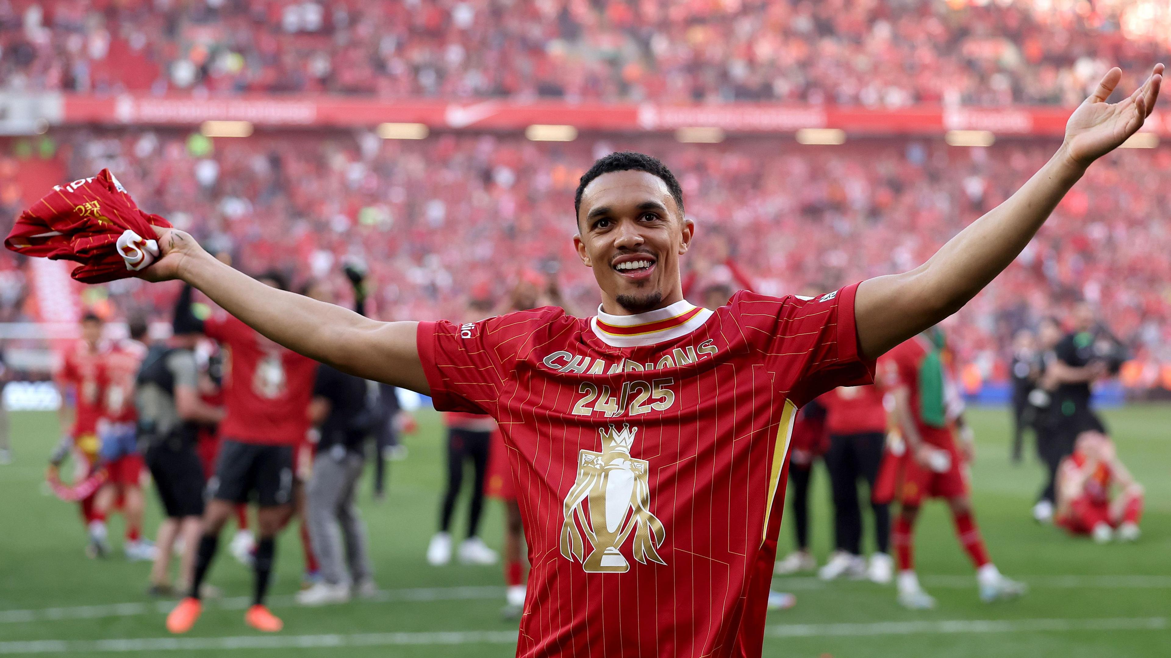 Liverpool's Trent Alexander-Arnold celebrates in front of the Kop after winning the Premier League title