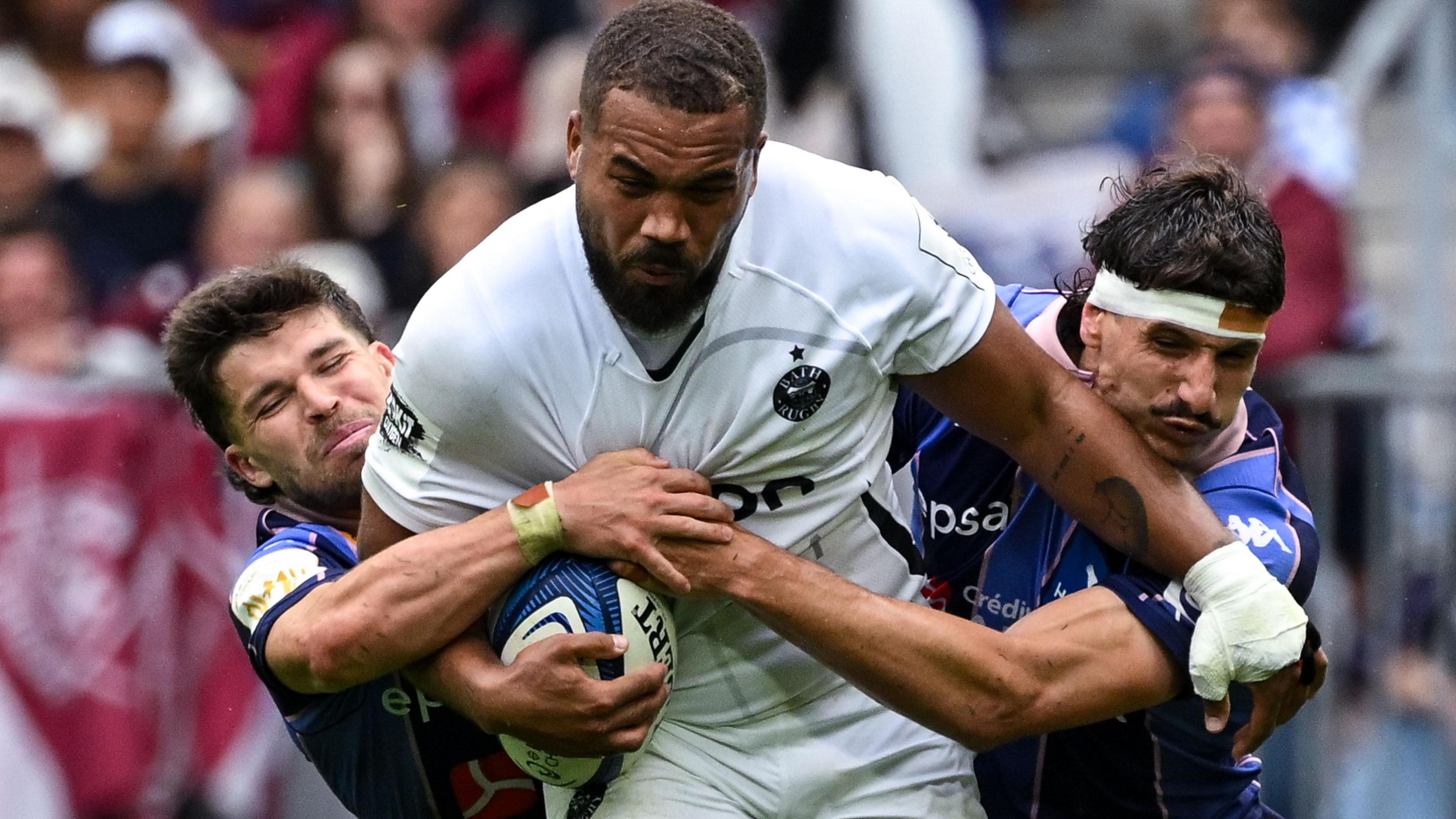 Bath's Ollie Lawrence is tackled by Bordeaux players