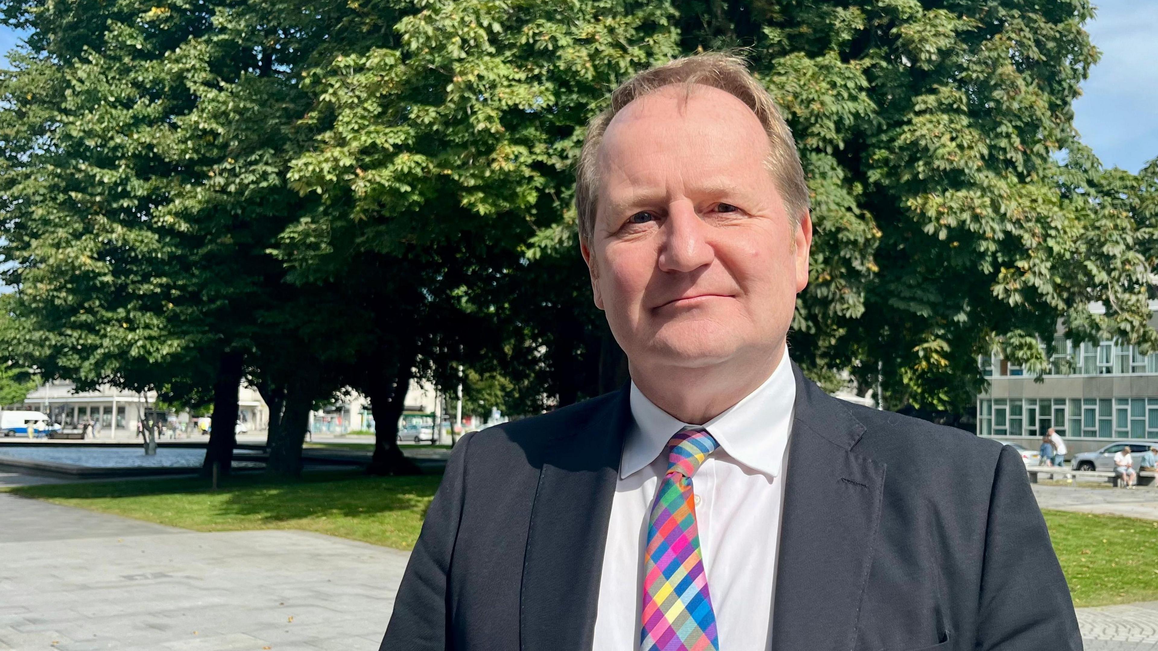 Stuart Elford, head of the Devon and Plymouth Chamber of Commerce, wearing a brightly-coloured tie, white shirt and dark jacket.