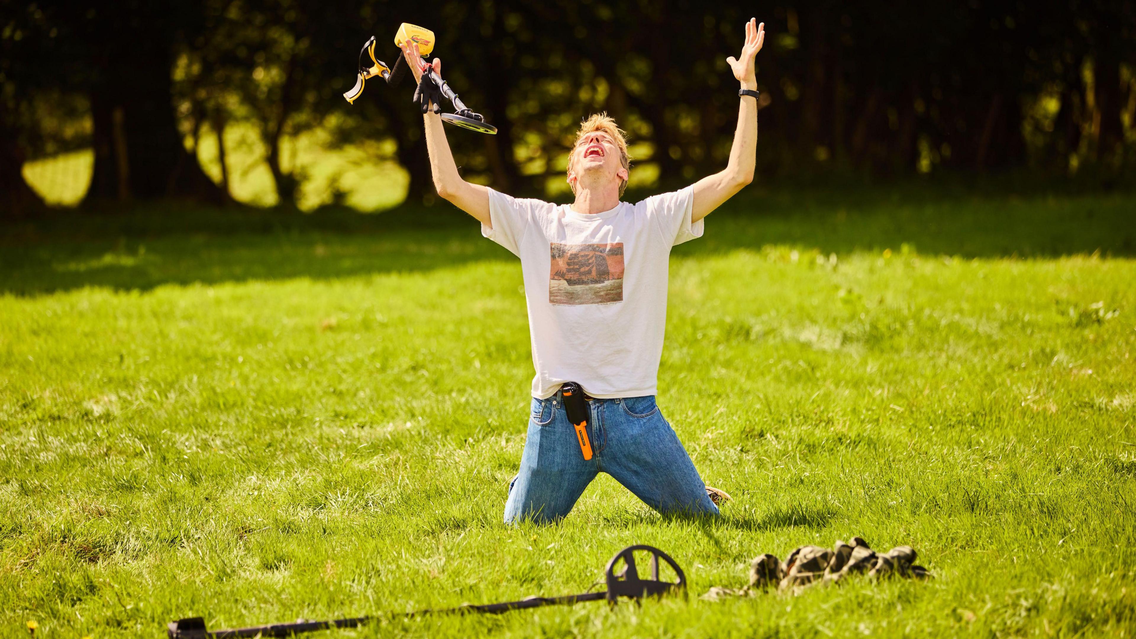 Charlie Cooper in a field with metal detector equipment