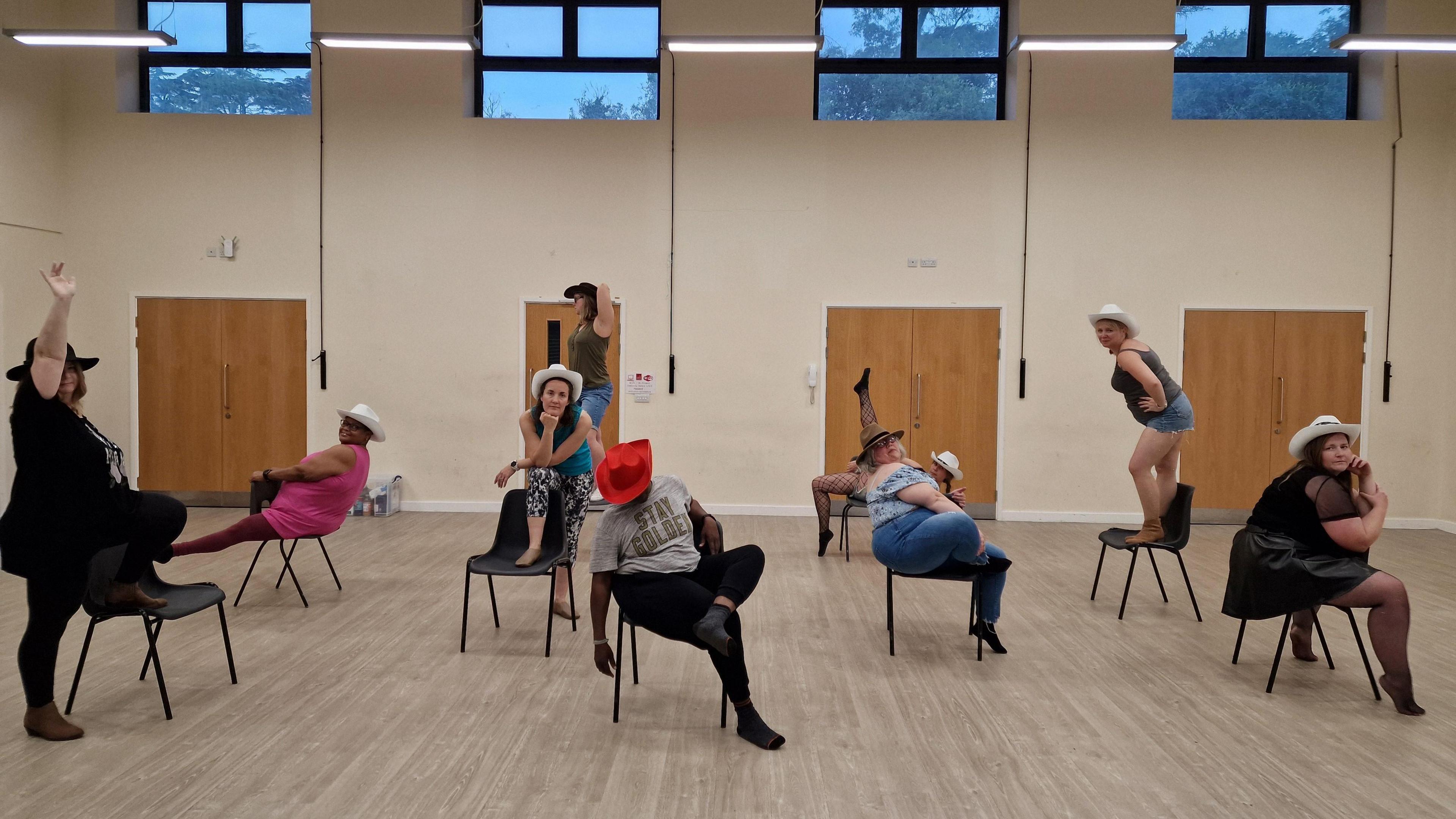 A class of burlesque dancers performing a routine