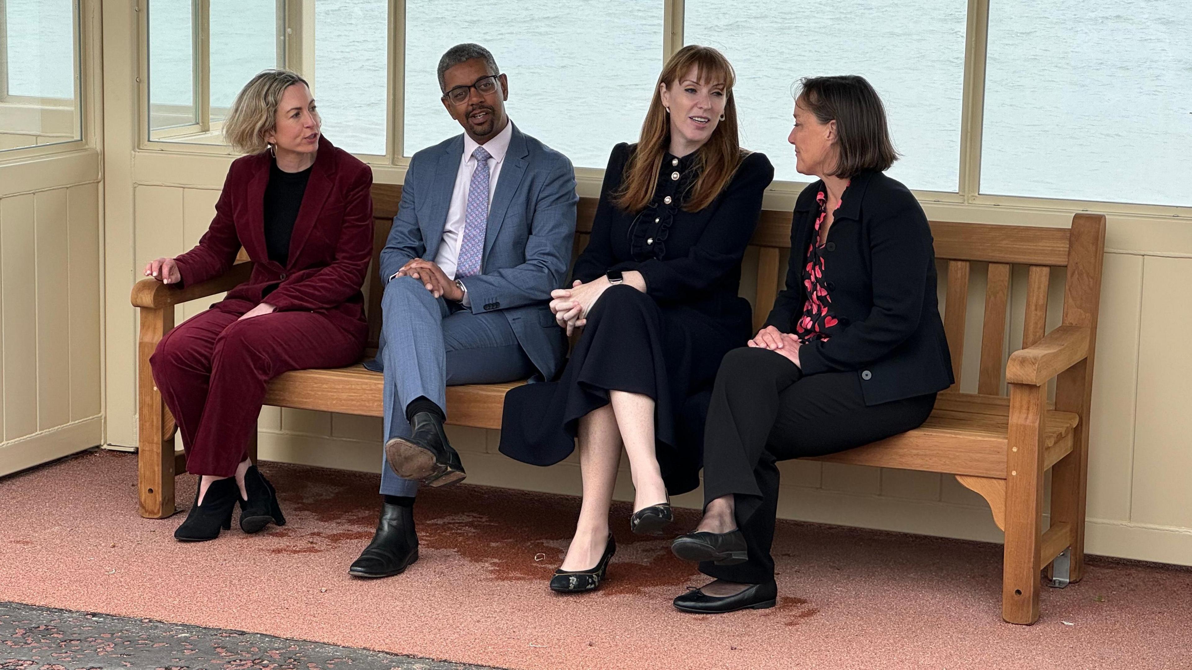 New Bangor and Aberconwy MP Claire Hughes (left) during the election campaign with Labour colleagues Vaughan Gething, Angela Rayner and Jo Stevens sitting on a bench in a seafront shelter