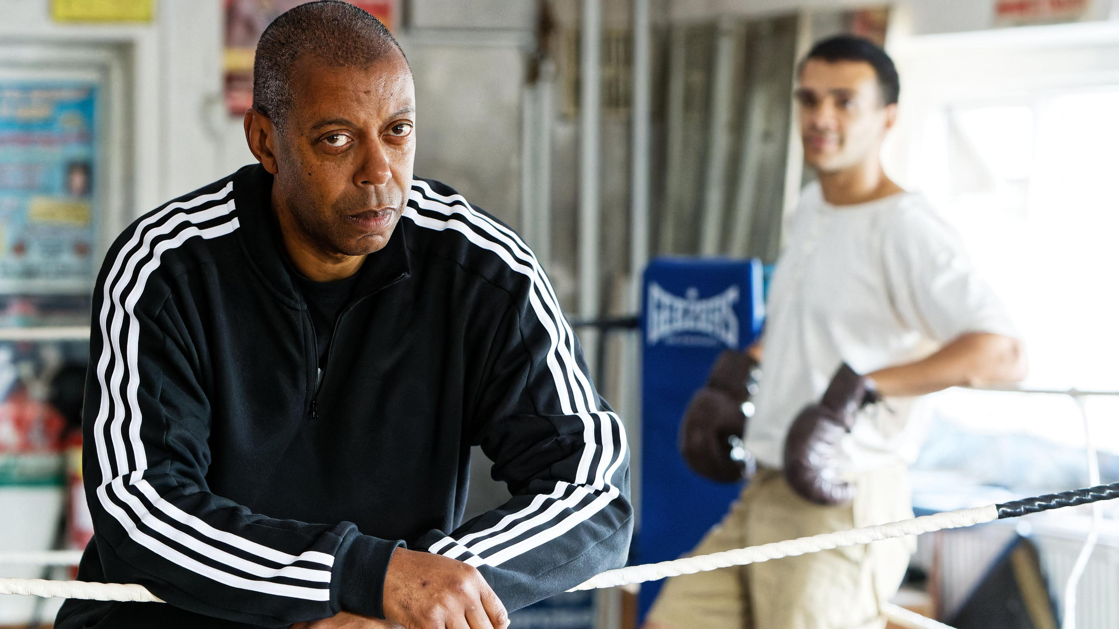 Kev McCurdy leans on the ropes while and actor catches his breath