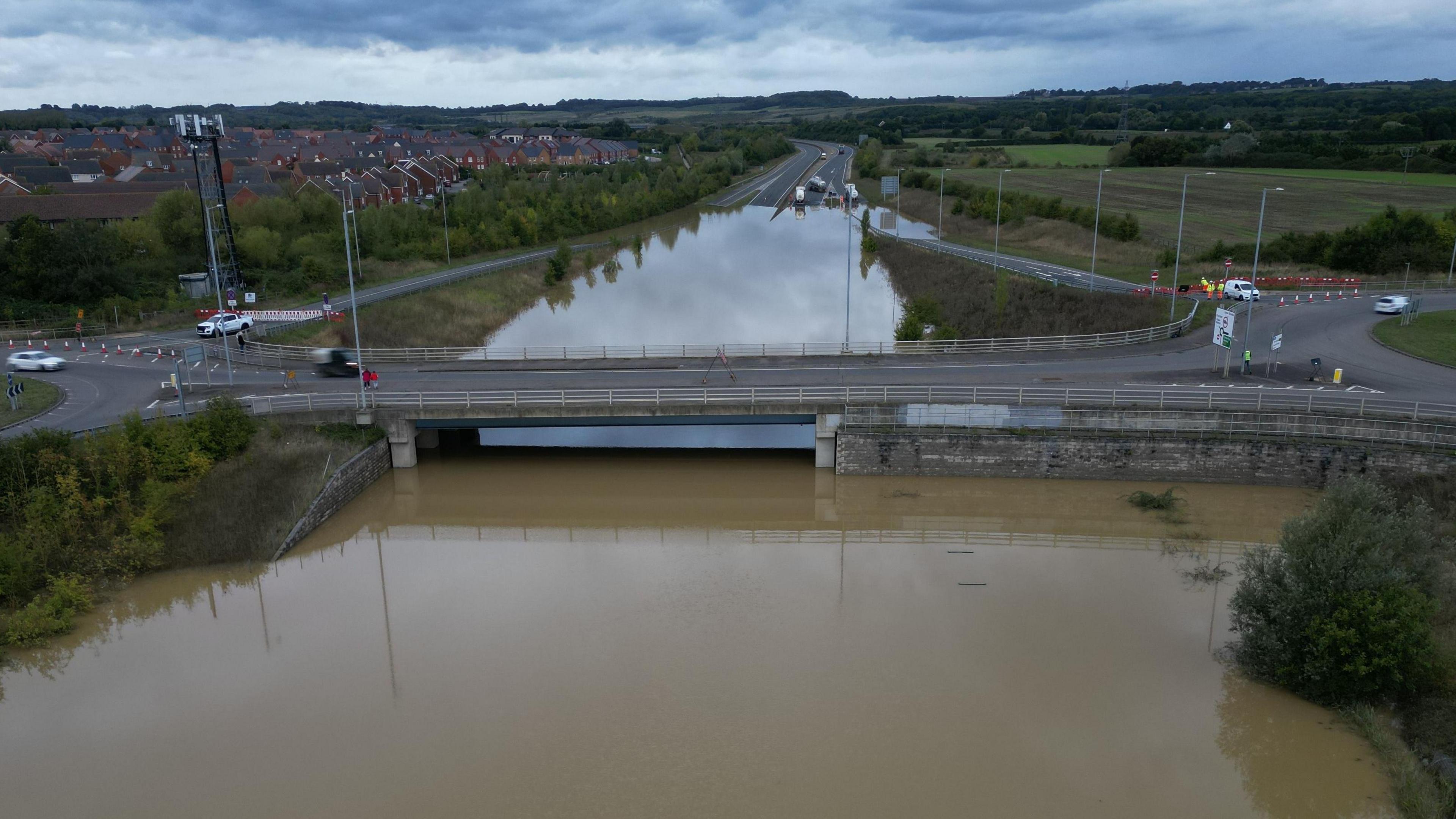 An aerial view of the dual carriageway of the A421 during September 2024 when heavy rainfall caused flooding which submerged the road under water. 