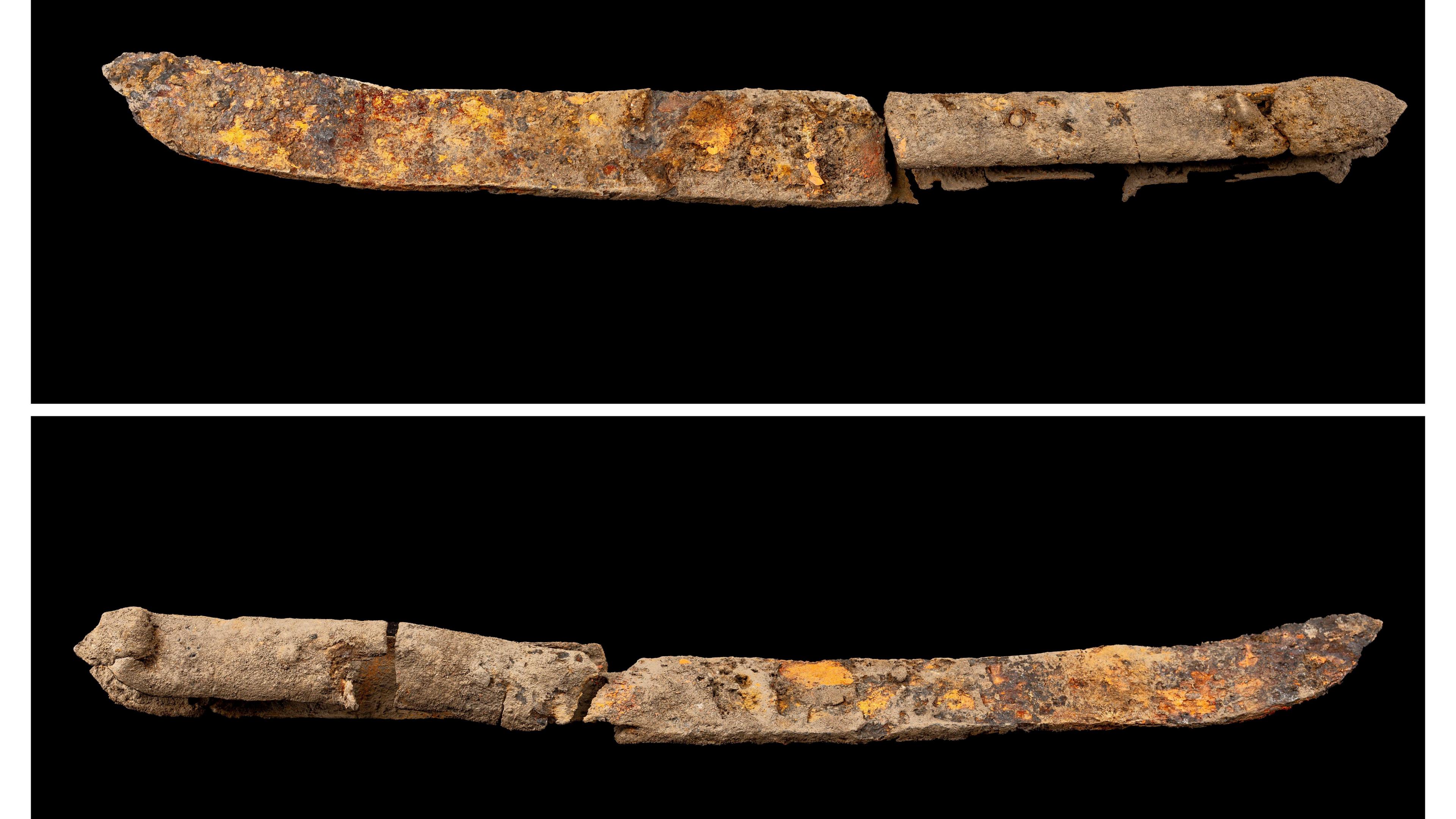 A very rusty knife pictured against a black backdrop