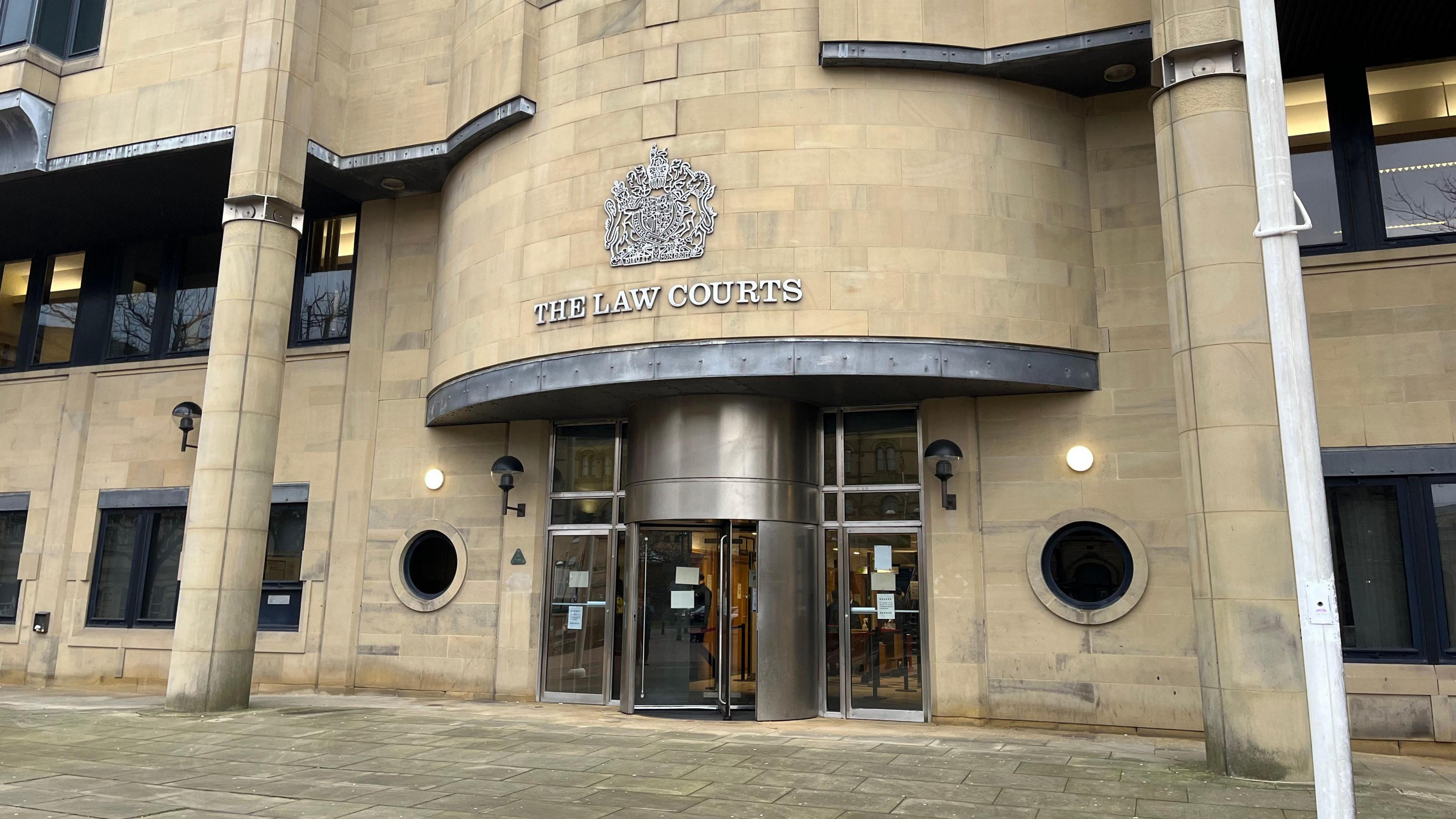 The front entrance to Bradford Crown Court. The brick is of a light colour, with no pedestrians in shot outside the building. 