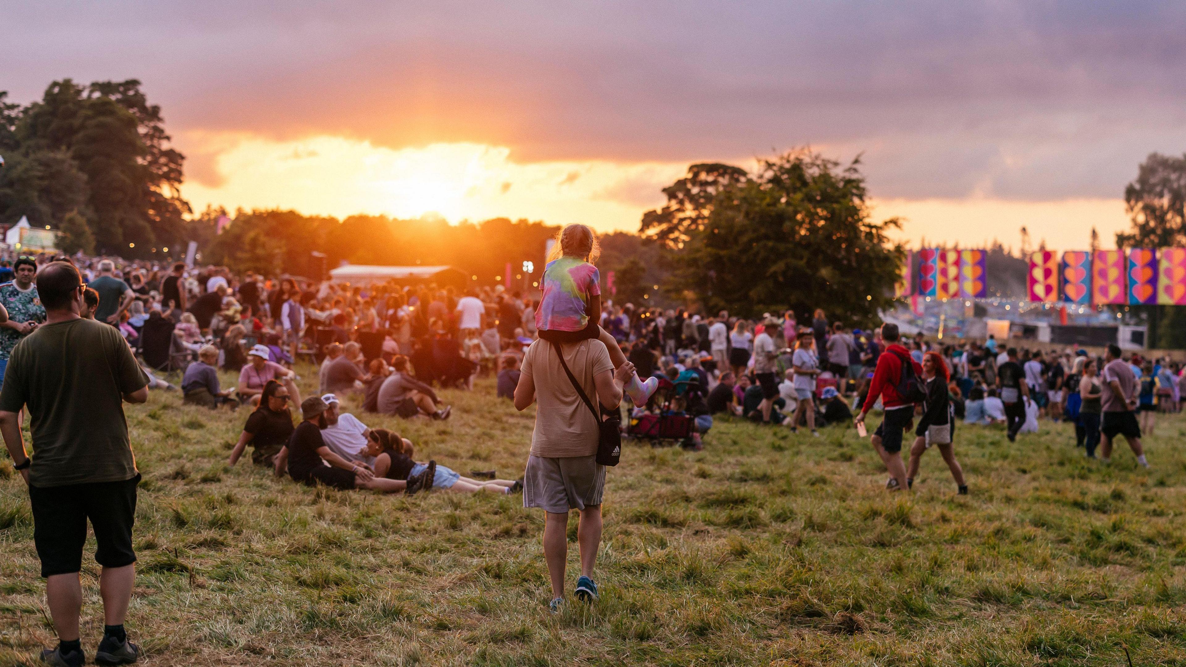 Festival goers in the fields at Kendal Calling 2024