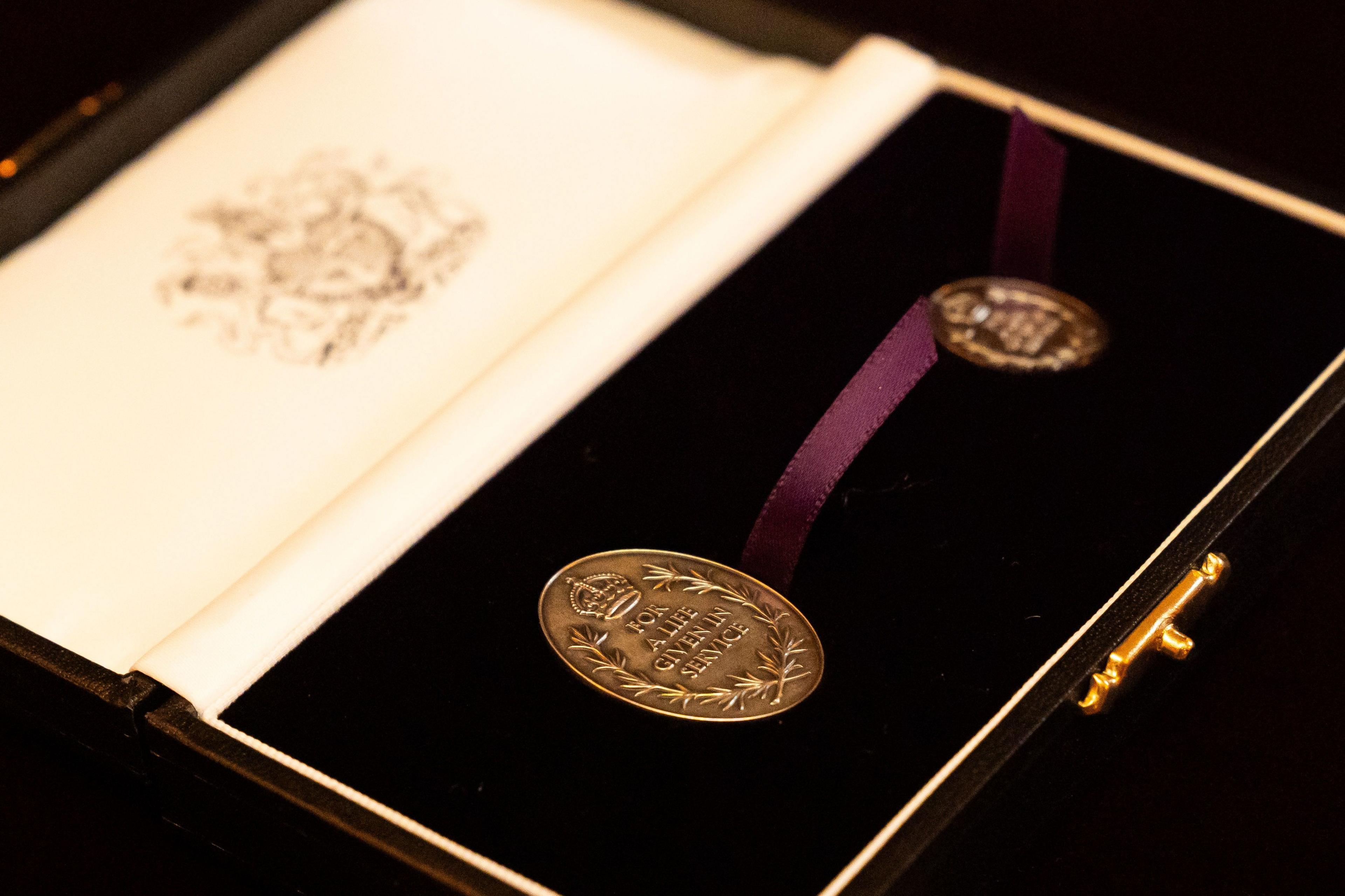 A picture of the awards with the inscription: "For a life given in service."