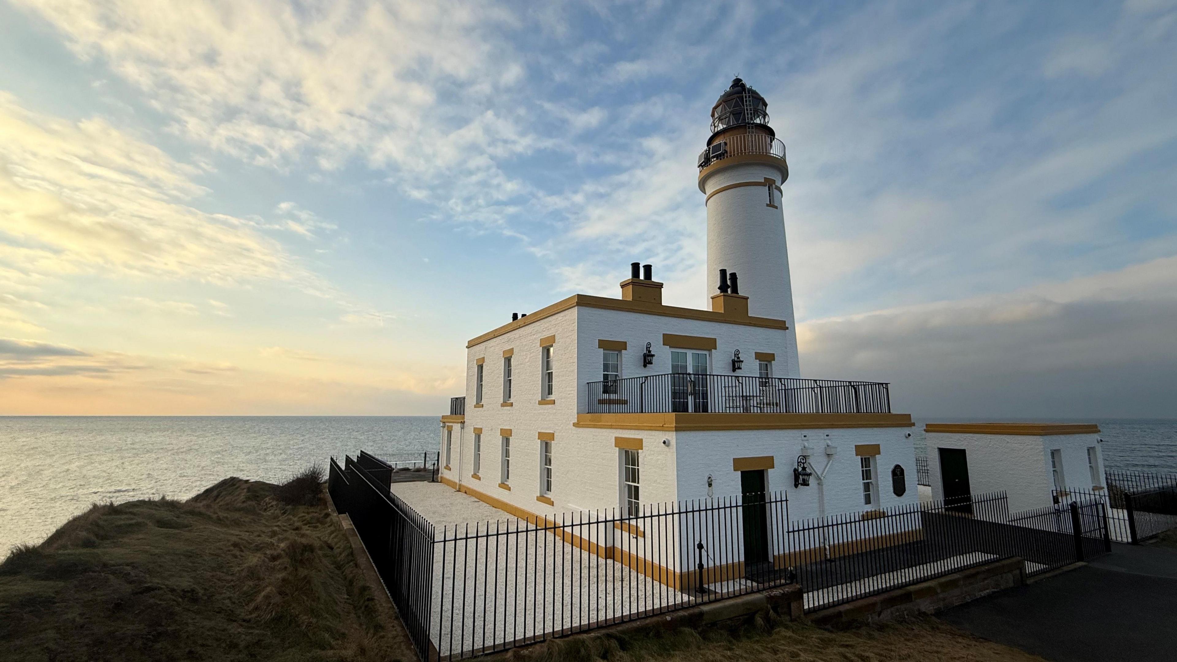 A white and yellow lighthouse