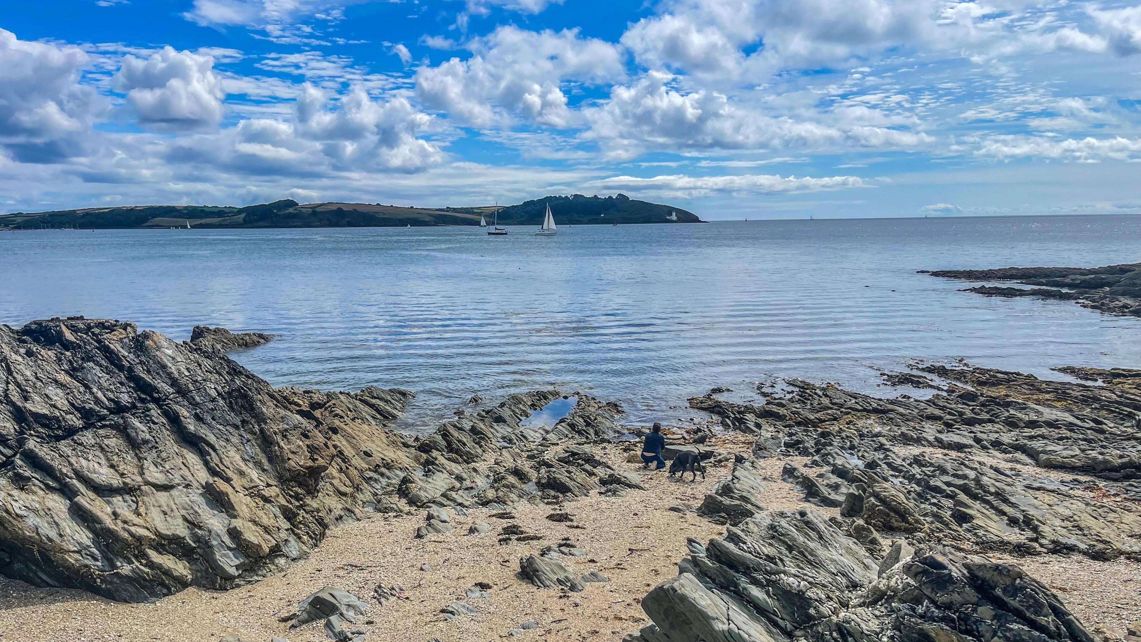 Rocks leading to water on a sunny day.