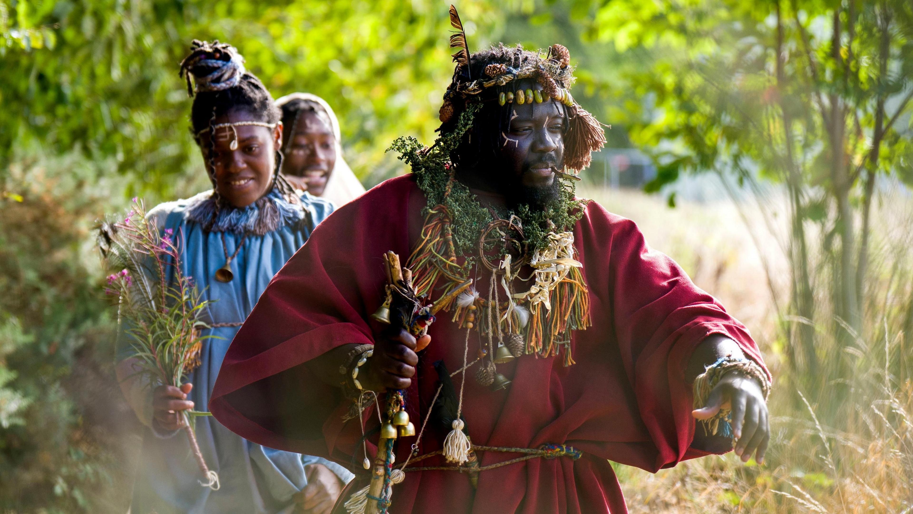 The three members of the tribe walk through the forest, with Kofi Offeh at the front.