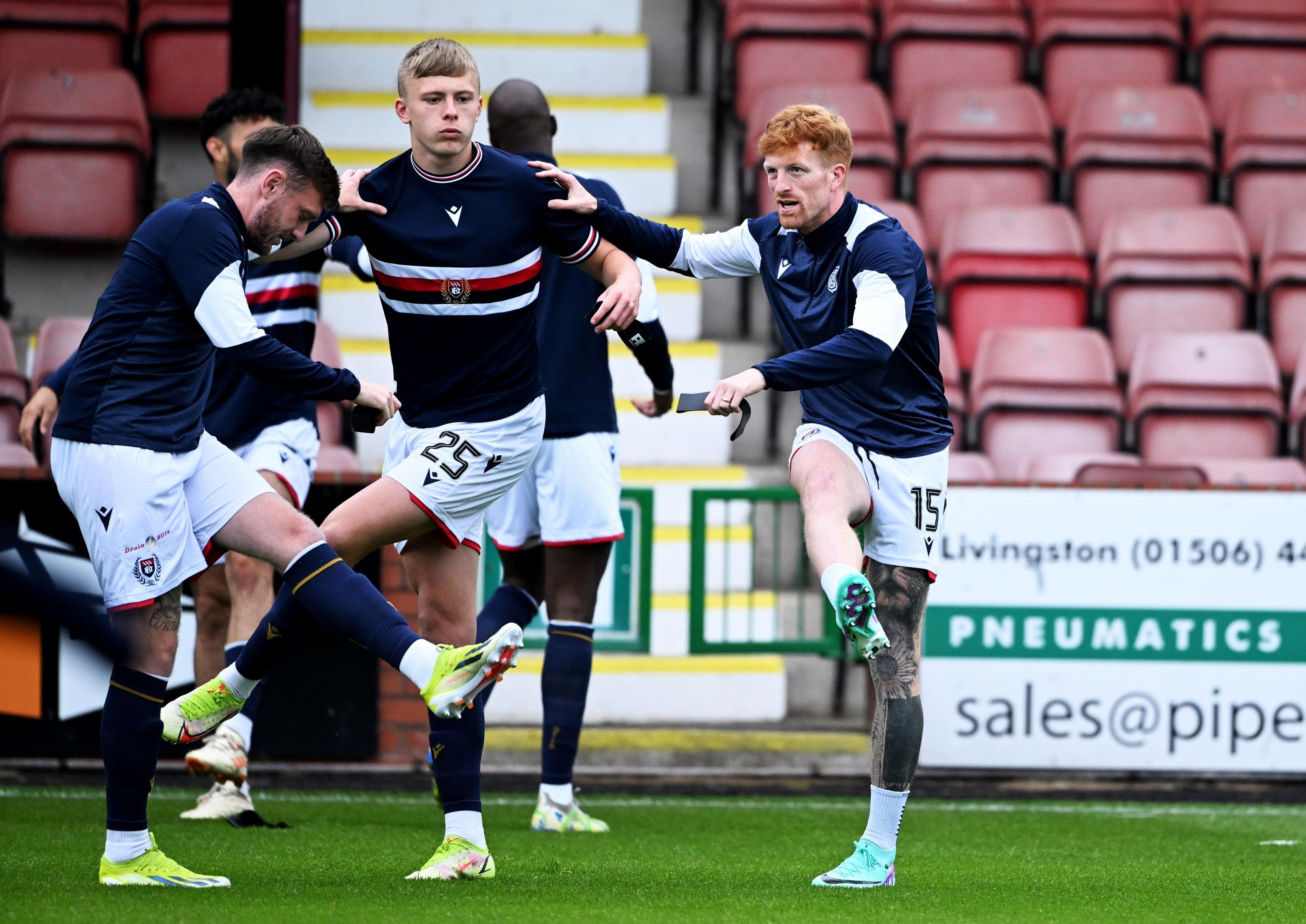 New Dundee signing Simon Murray (right) warms up against Dunfermline Athletic