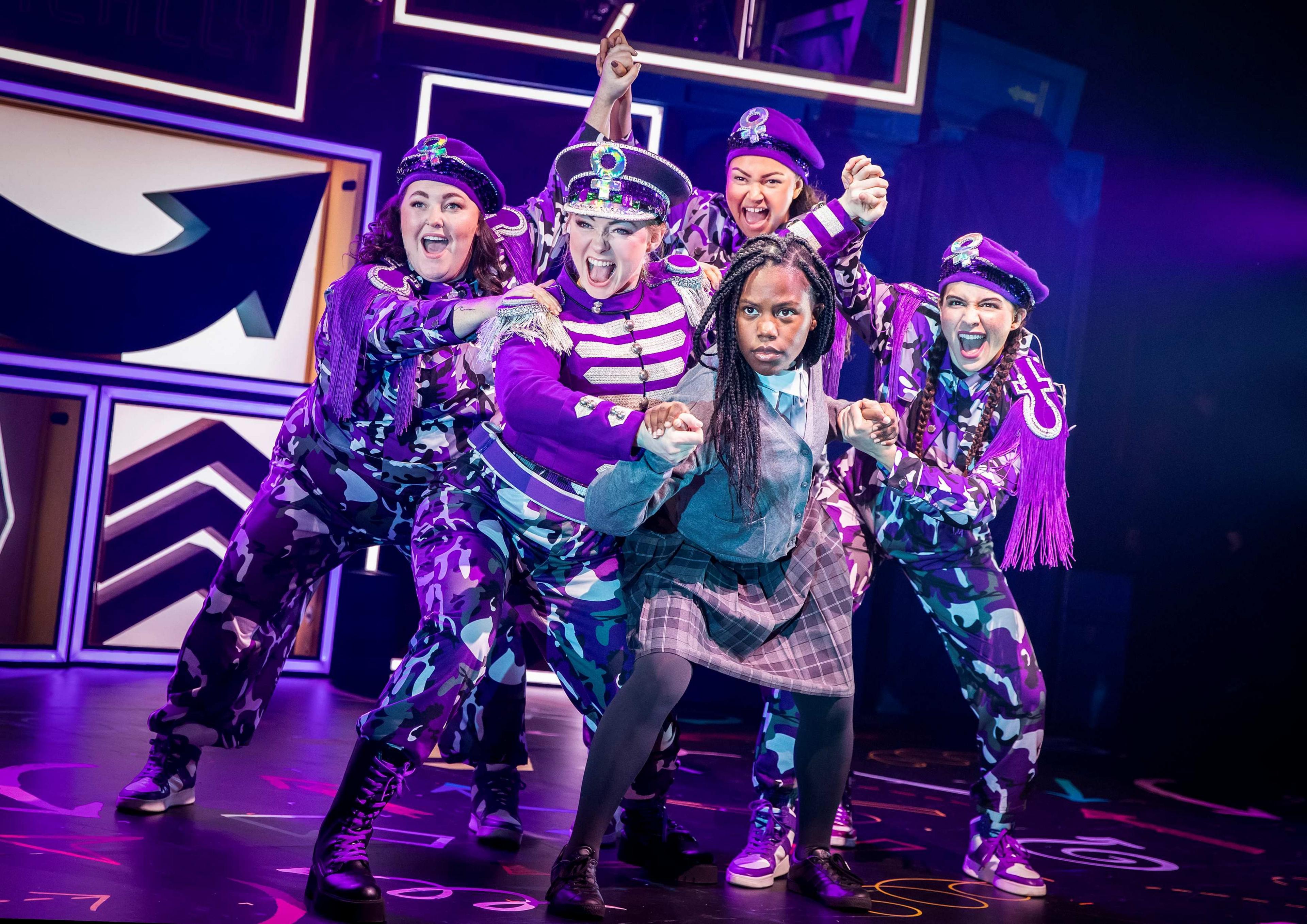 A group shot of five members of the cast dancing and singing on stage in Fantastically Great Women Who Changed the World