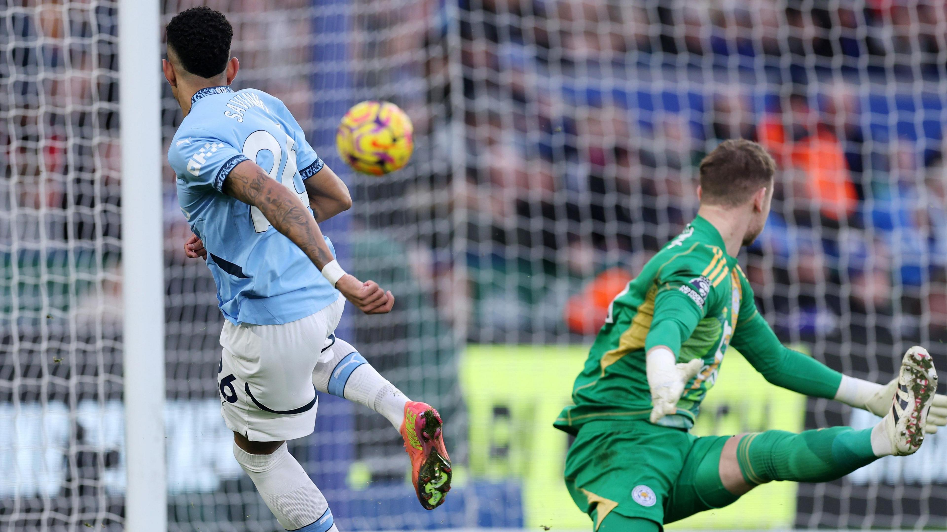 Savinho scores past Jakub Stolarczyk to put Manchester City ahead.