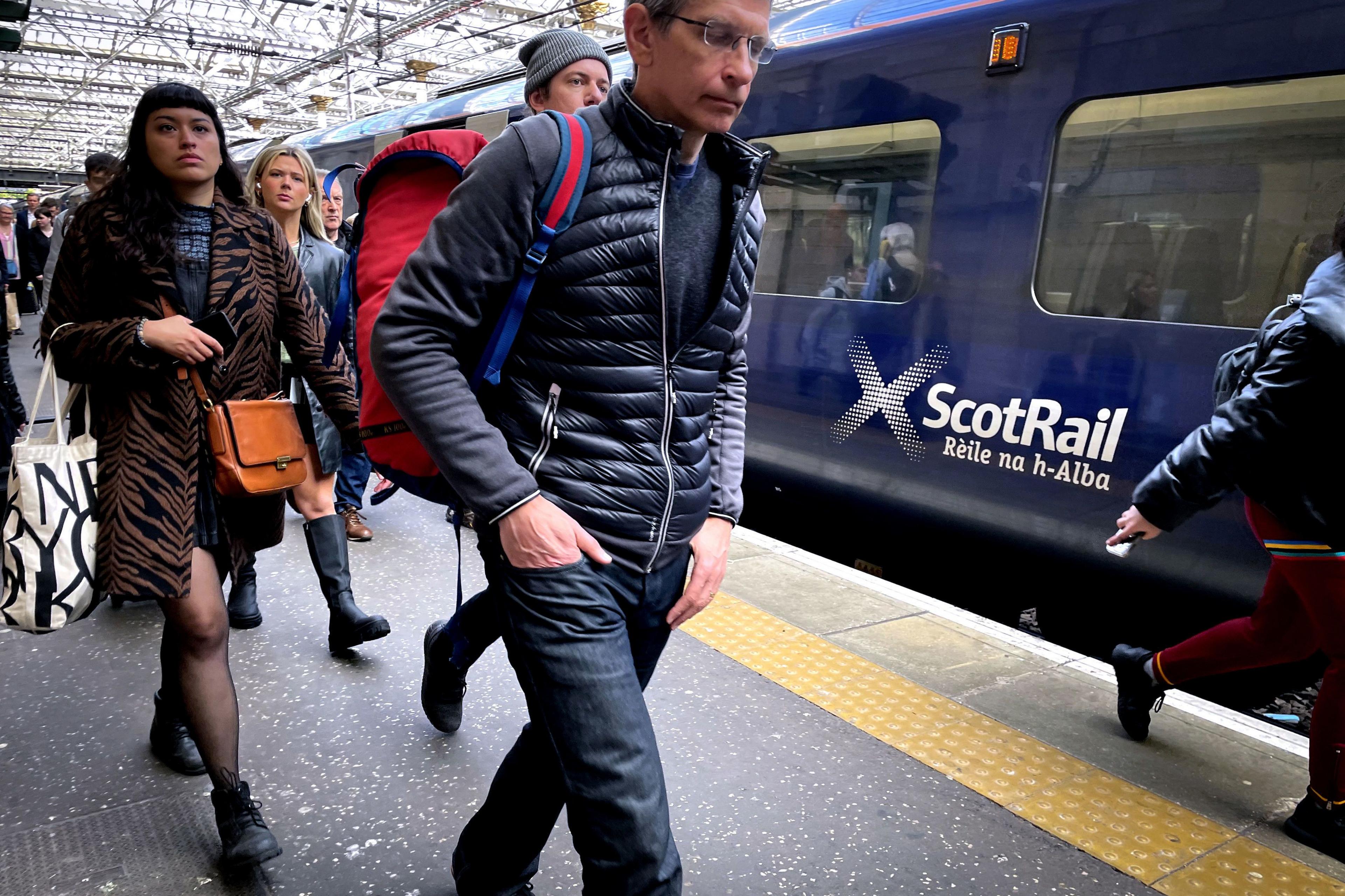 Passengers who have just got off a ScotRail train walking through Waverley Station in Edinburgh 