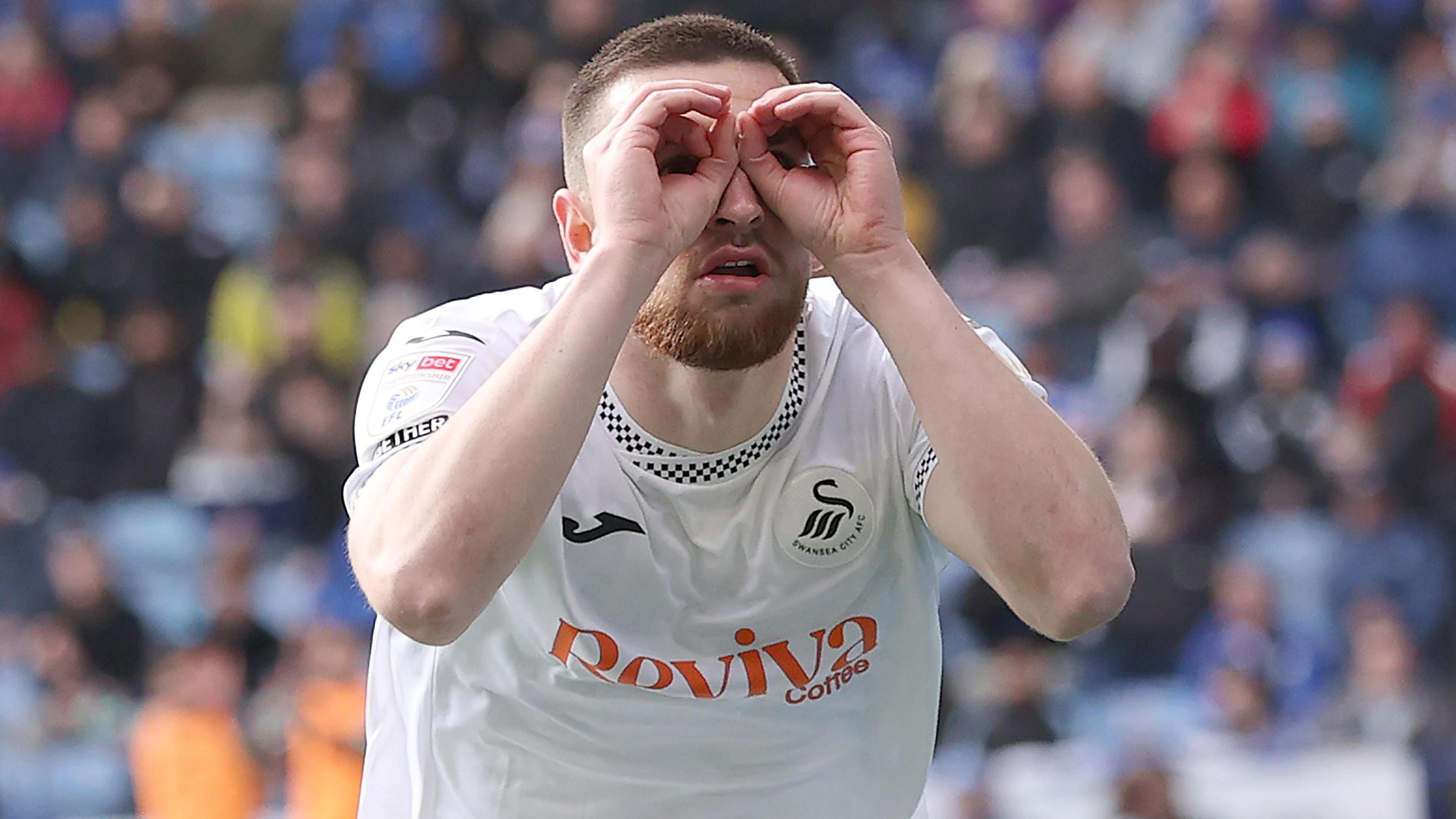 Zan Vipotnik celebrates a extremity for Swansea City pinch his 'binoculars' celebration