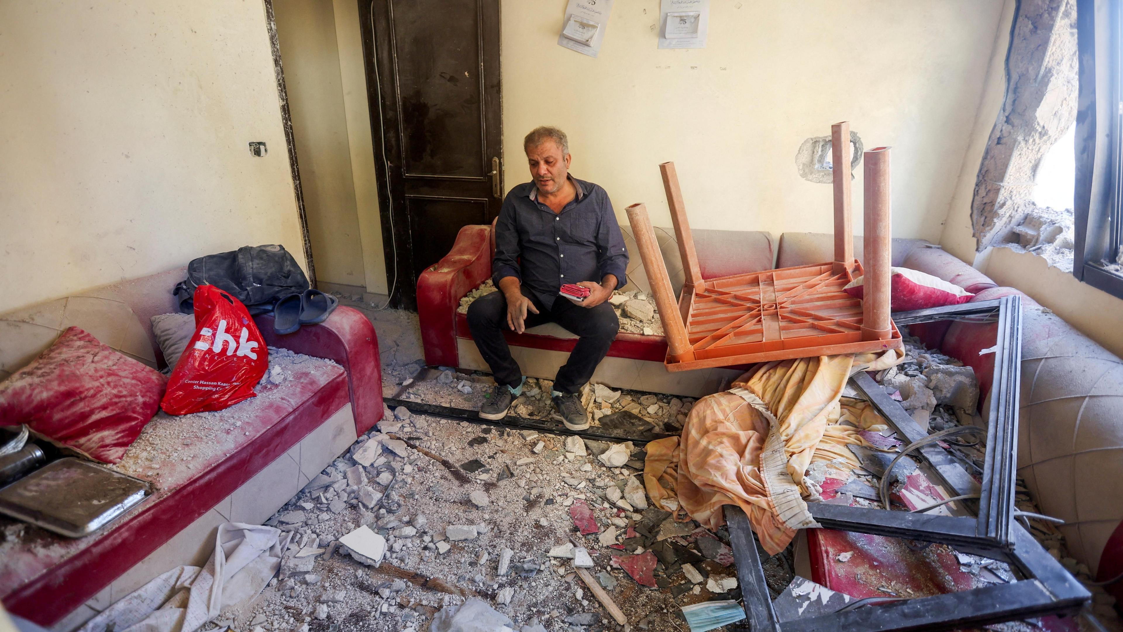 Moussa Zahran sits inside his damaged apartment in Barja, Lebanon (6 November 2024)