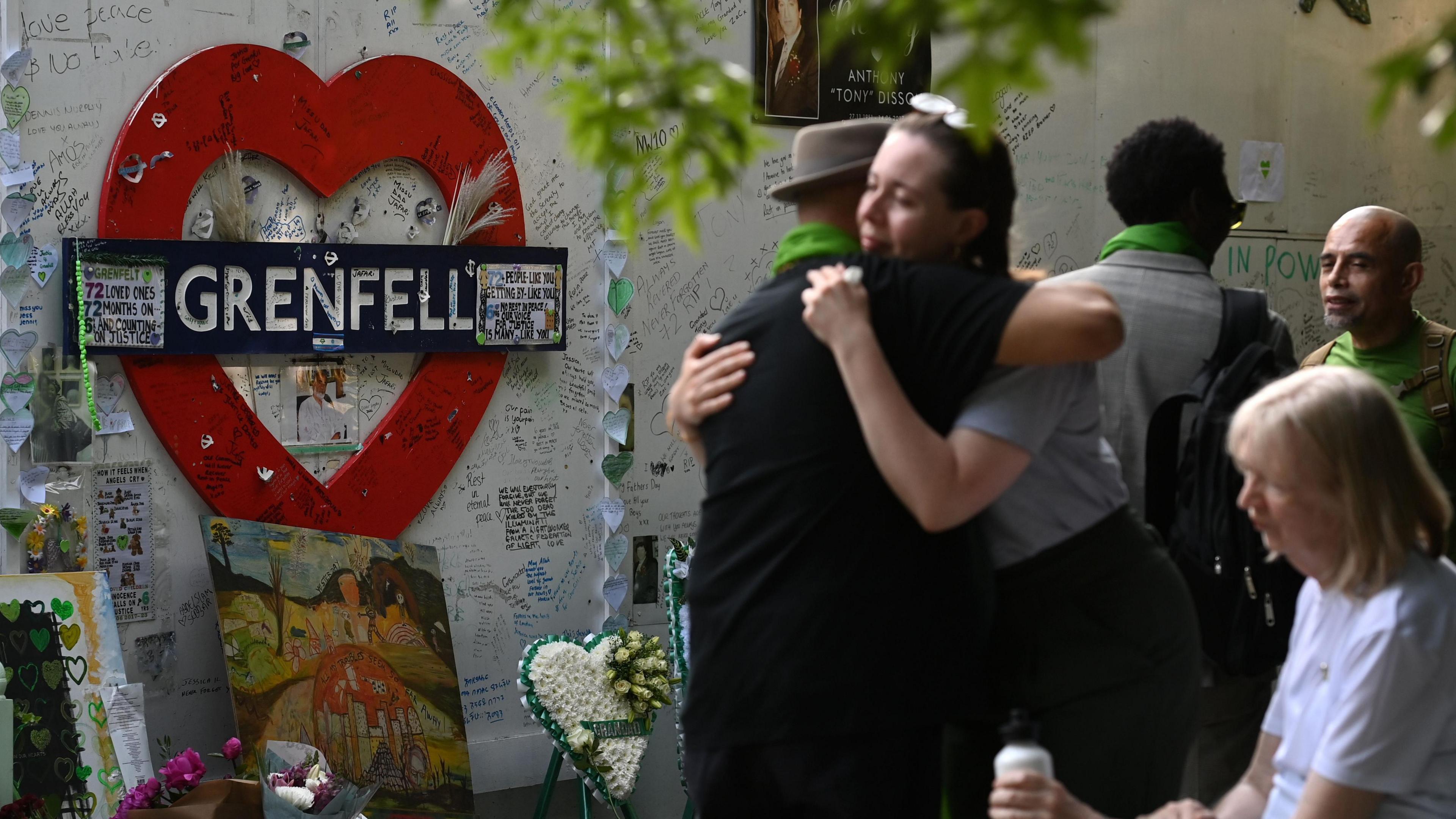 People remember the lives lost at the Grenfell wall in London on 14 June 2023