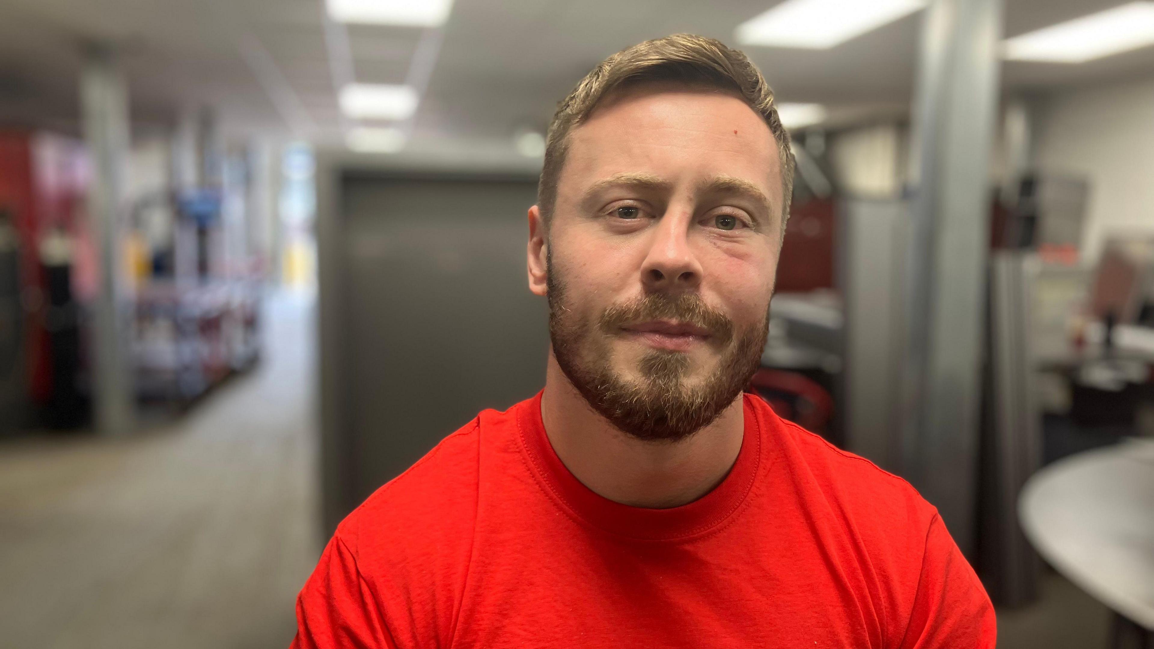 A man wearing a Redhill Manufacturing tshirt