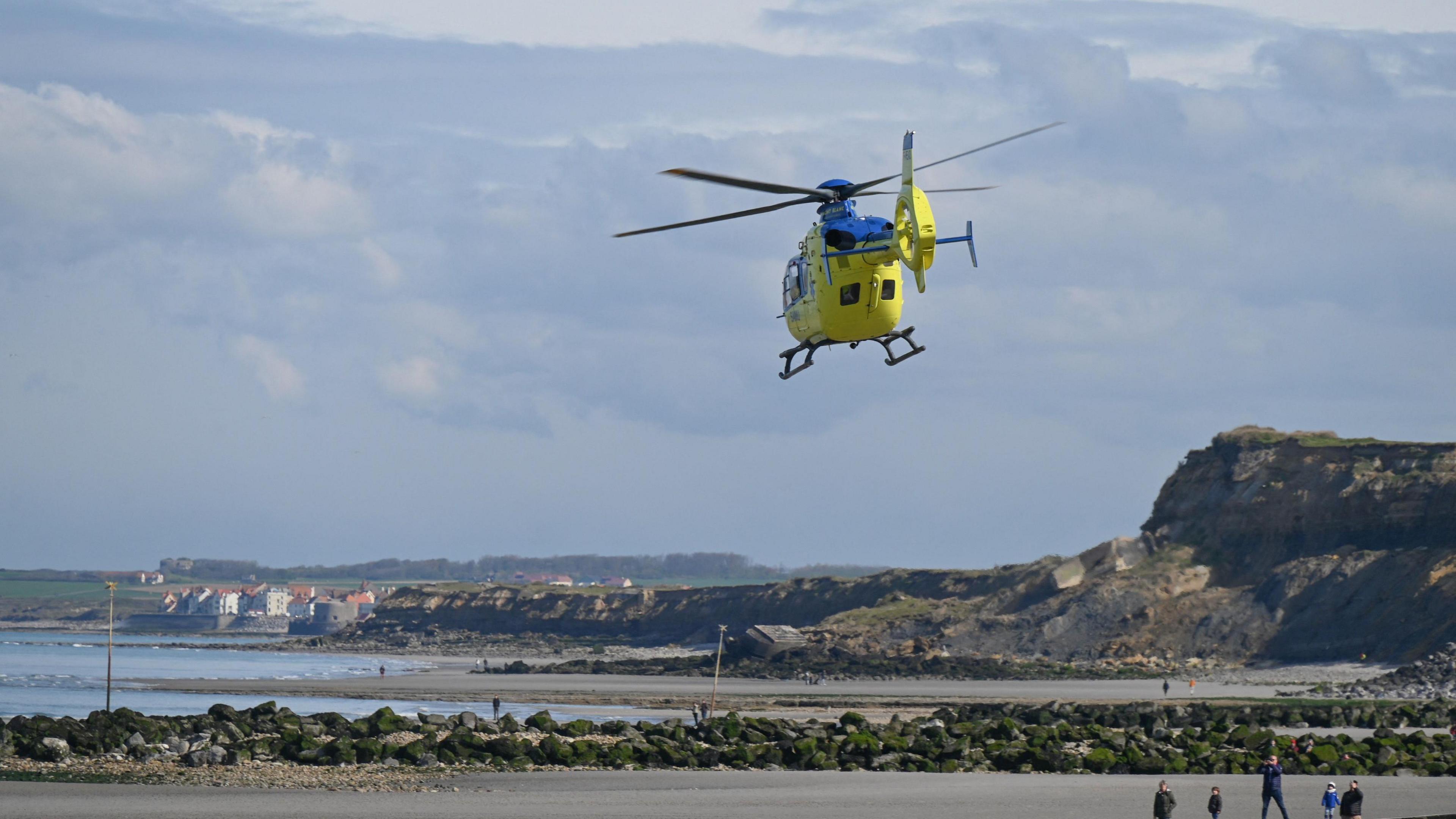 A French emergency helicopter takes off from the Wimereux dike on April 23, 2024, after the recovery of the bodies of five migrants, who died trying to cross the Channel to Britain.