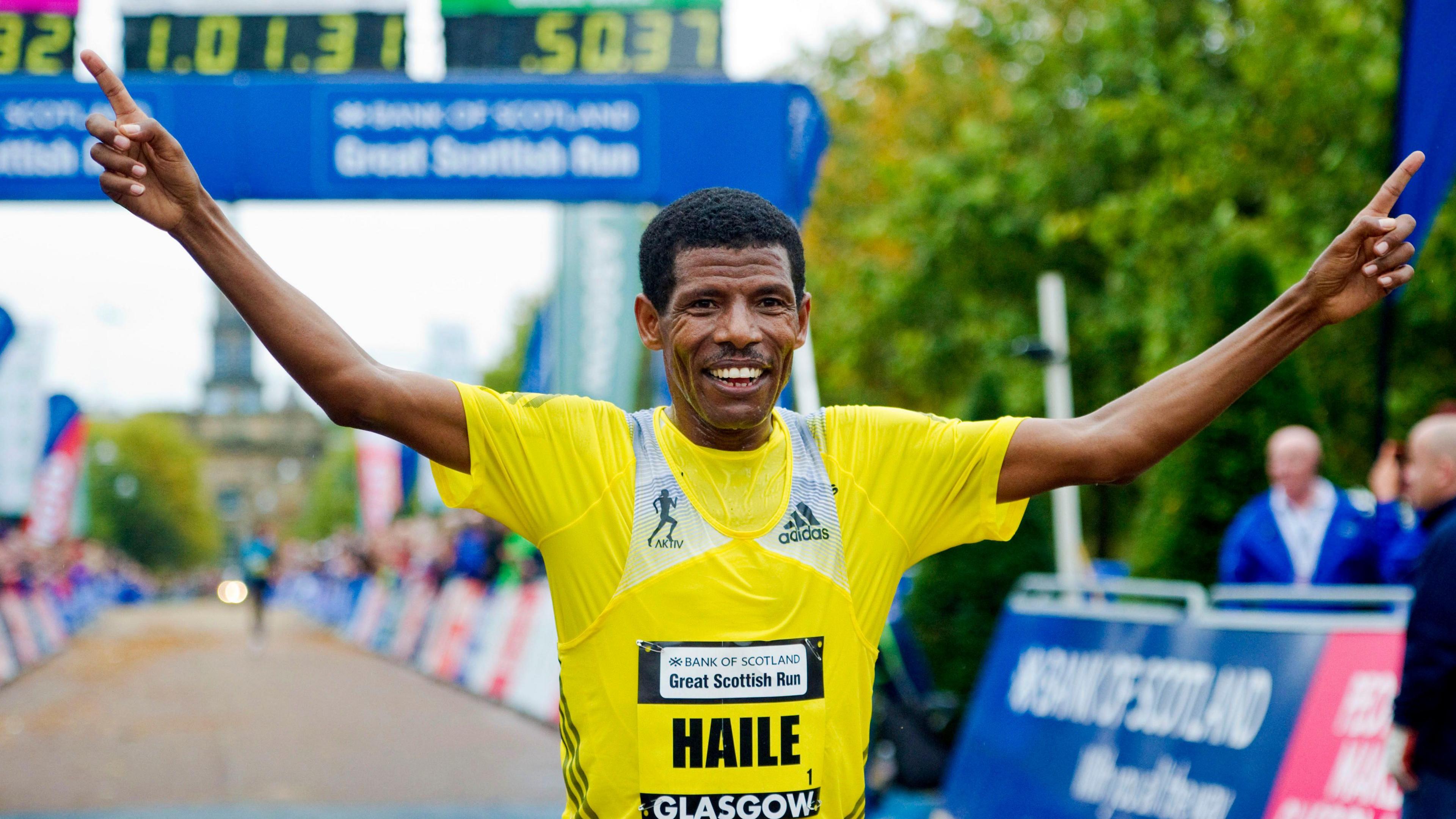 Double Olympic gold medallist Haile Gebrselassie with his arms raised aloft after winning the 2013 Great Scottish Run in Glasgow