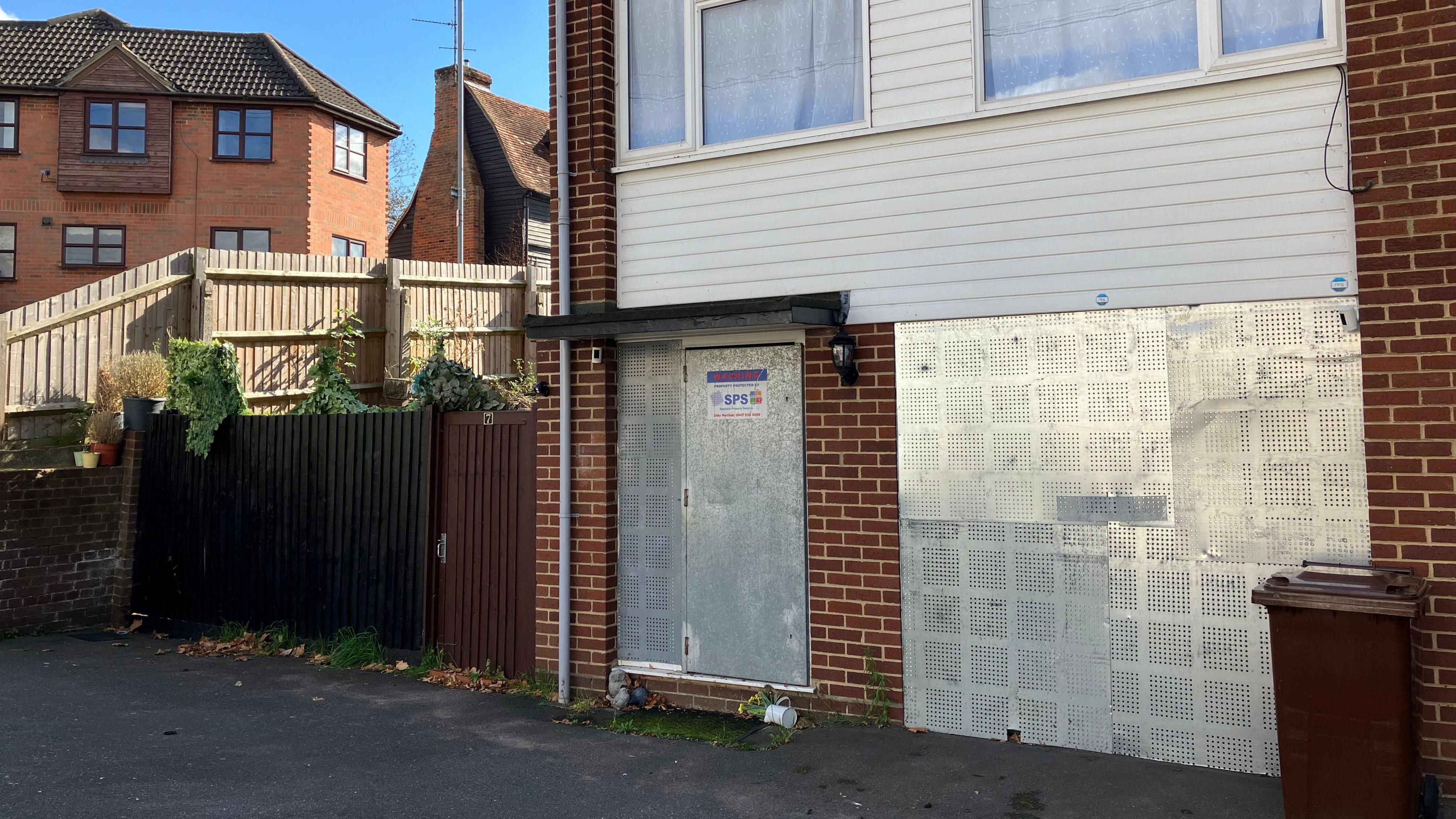 The McCullough property in Pump Hill. It has metal security barriers blocking the front door and windows.