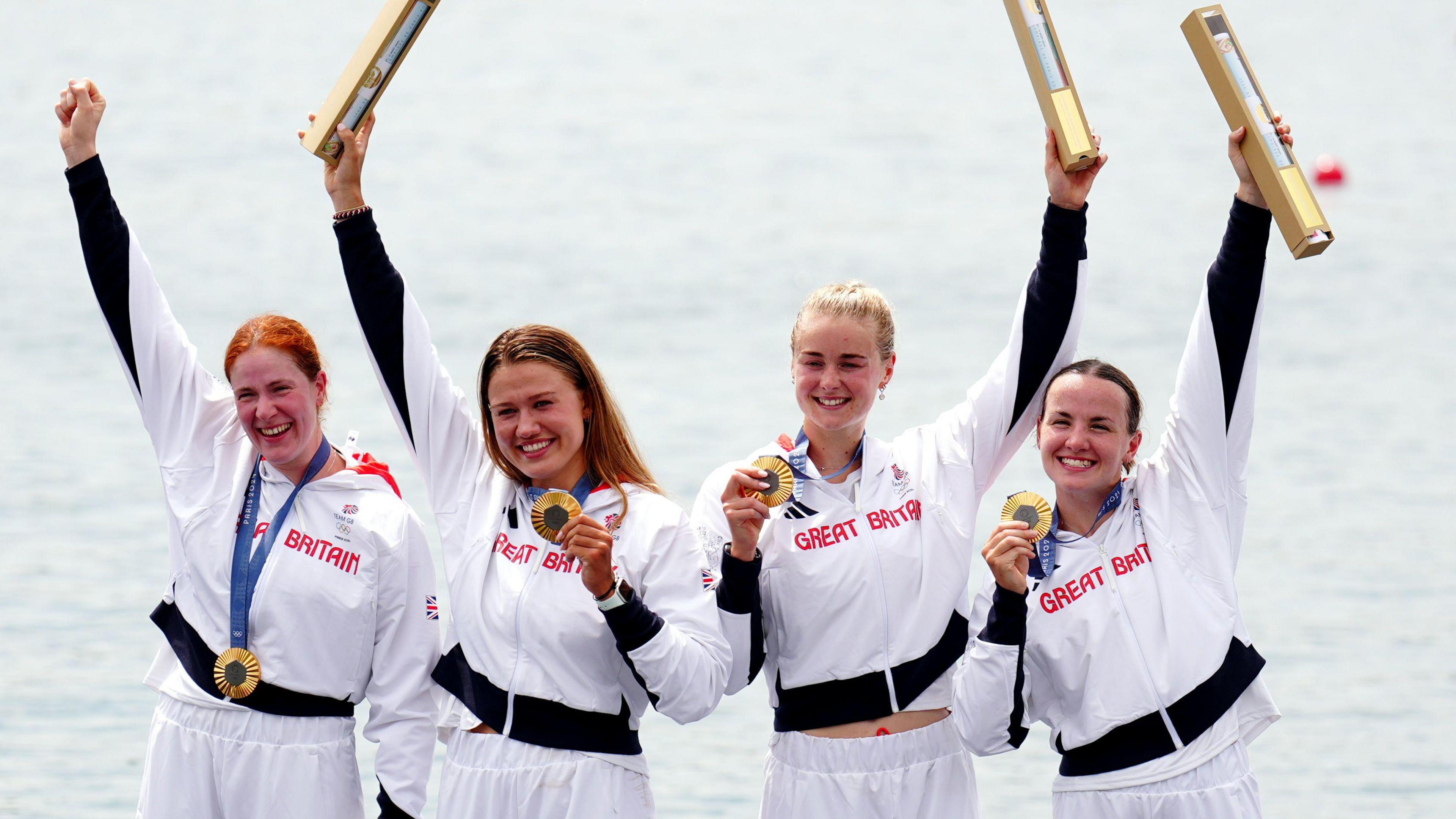 Great Britain’s Lauren Henry, Hannah Scott, Lola Anderson and Georgie Brayshaw celebrate with their gold medals following the Women's Quadruple Sculls Final at the Paris Olympics.