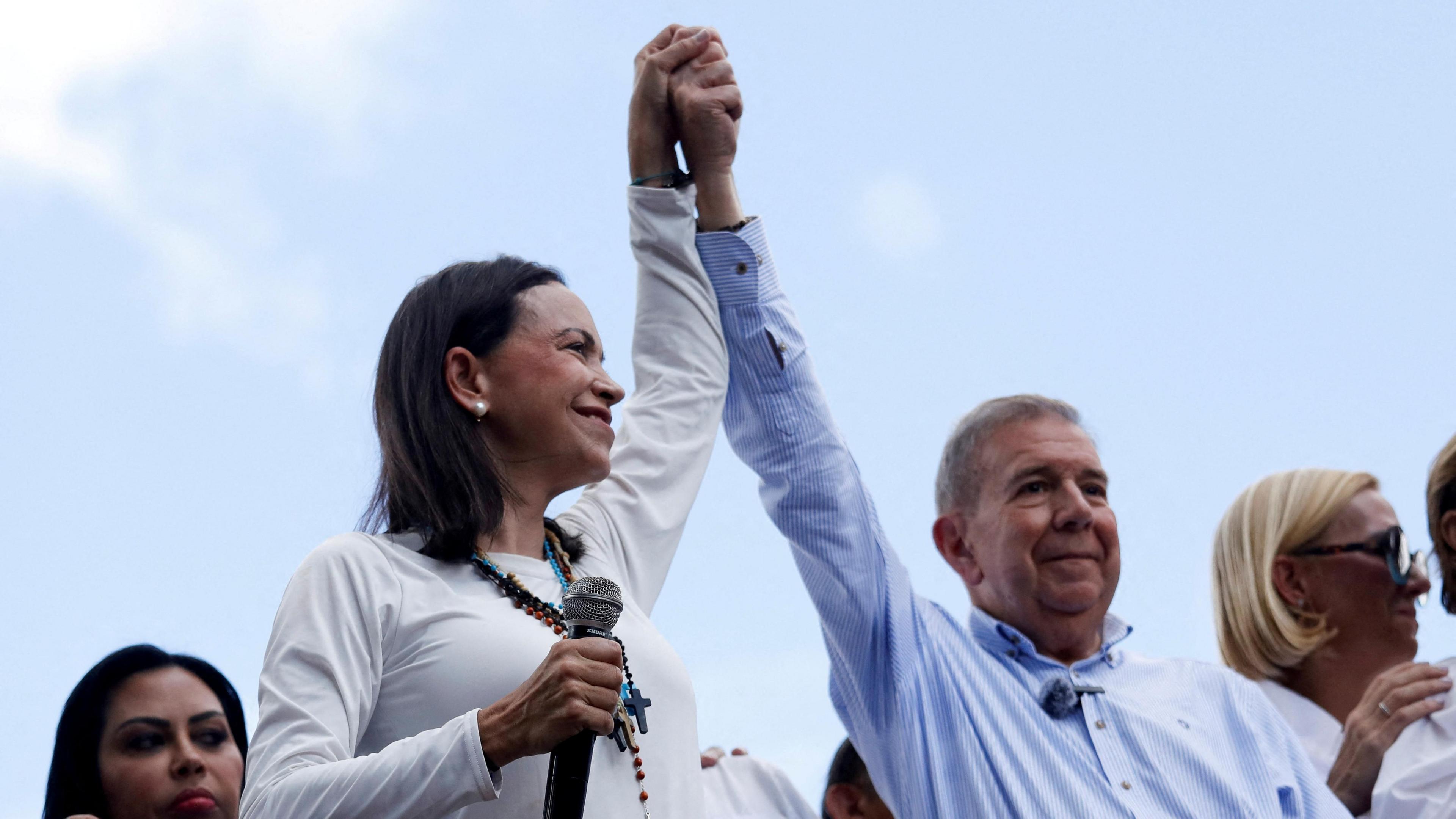 Opposition leader Maria Corina Machado and opposition candidate Edmundo González gesture as they address supporters, in Caracas, Venezuela