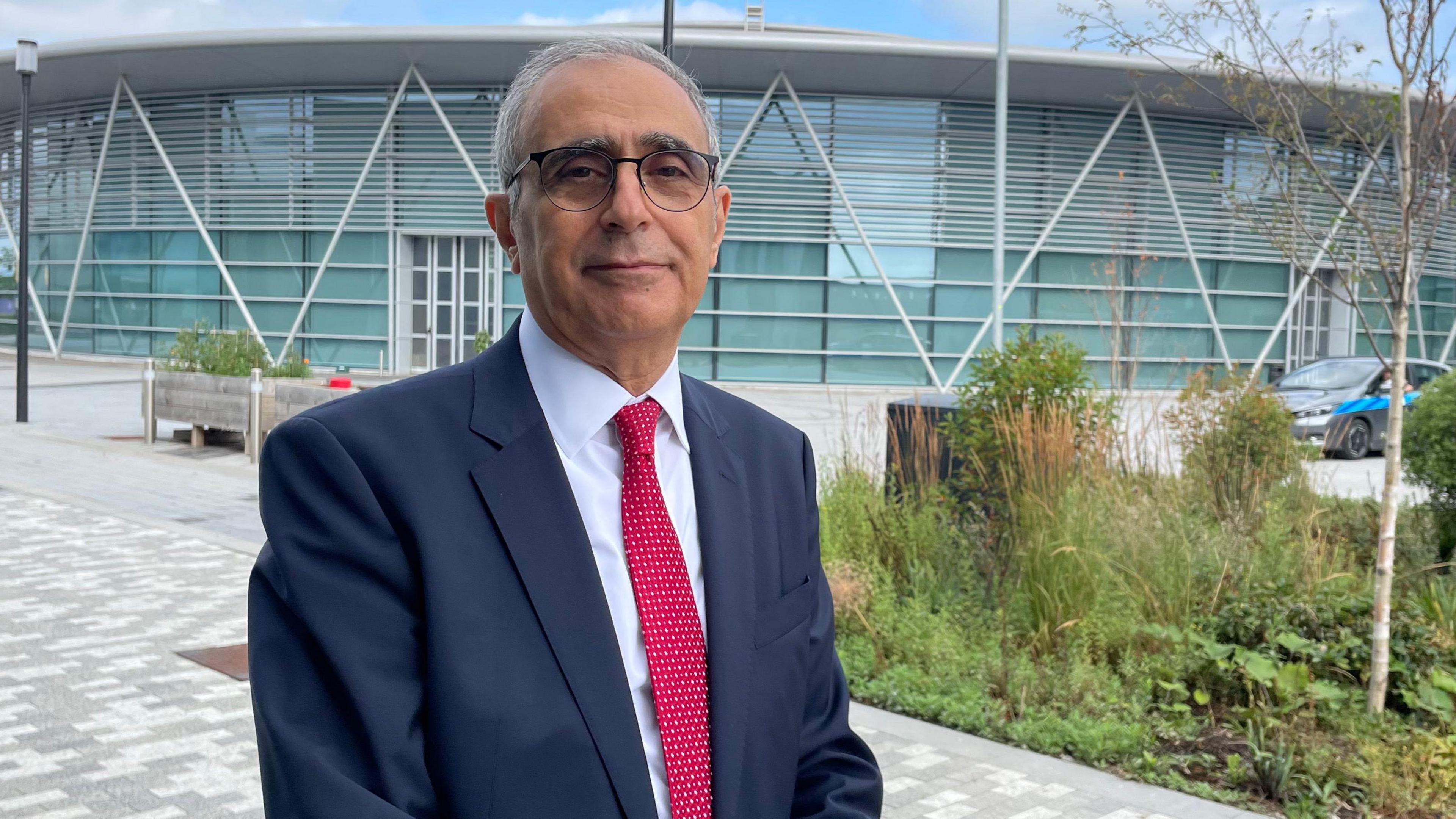 Professor of Energy Engineering and Head of the Energy Innovation Centre, Mohamed Pourkashanian, wearing a navy blue suit, light shirt and red tie.