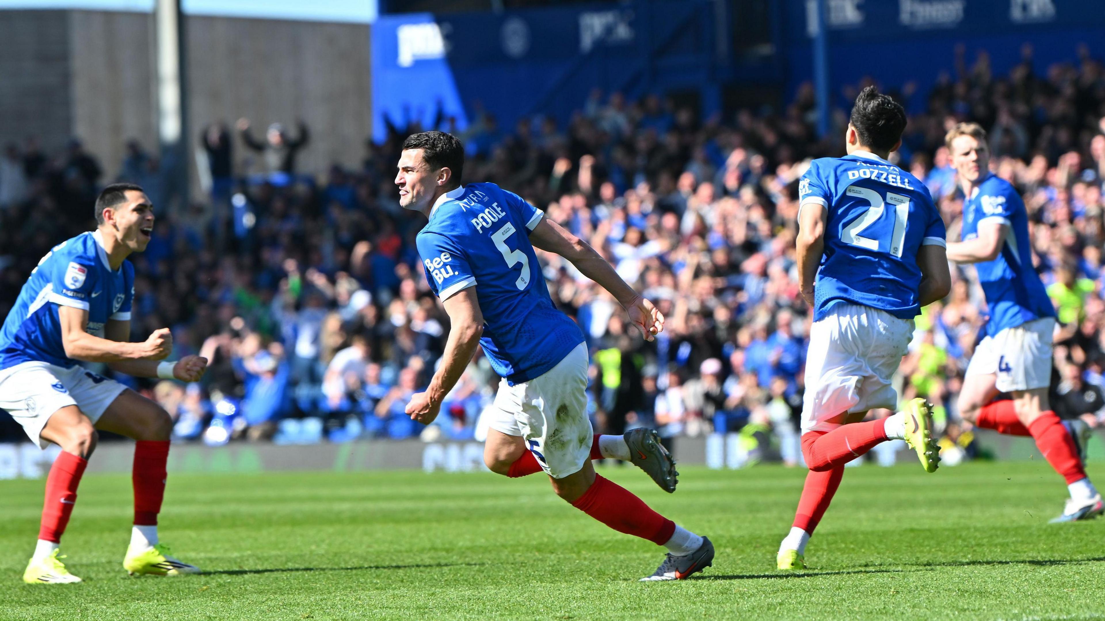 Portsmouth celebrate after scoring against Oxford United