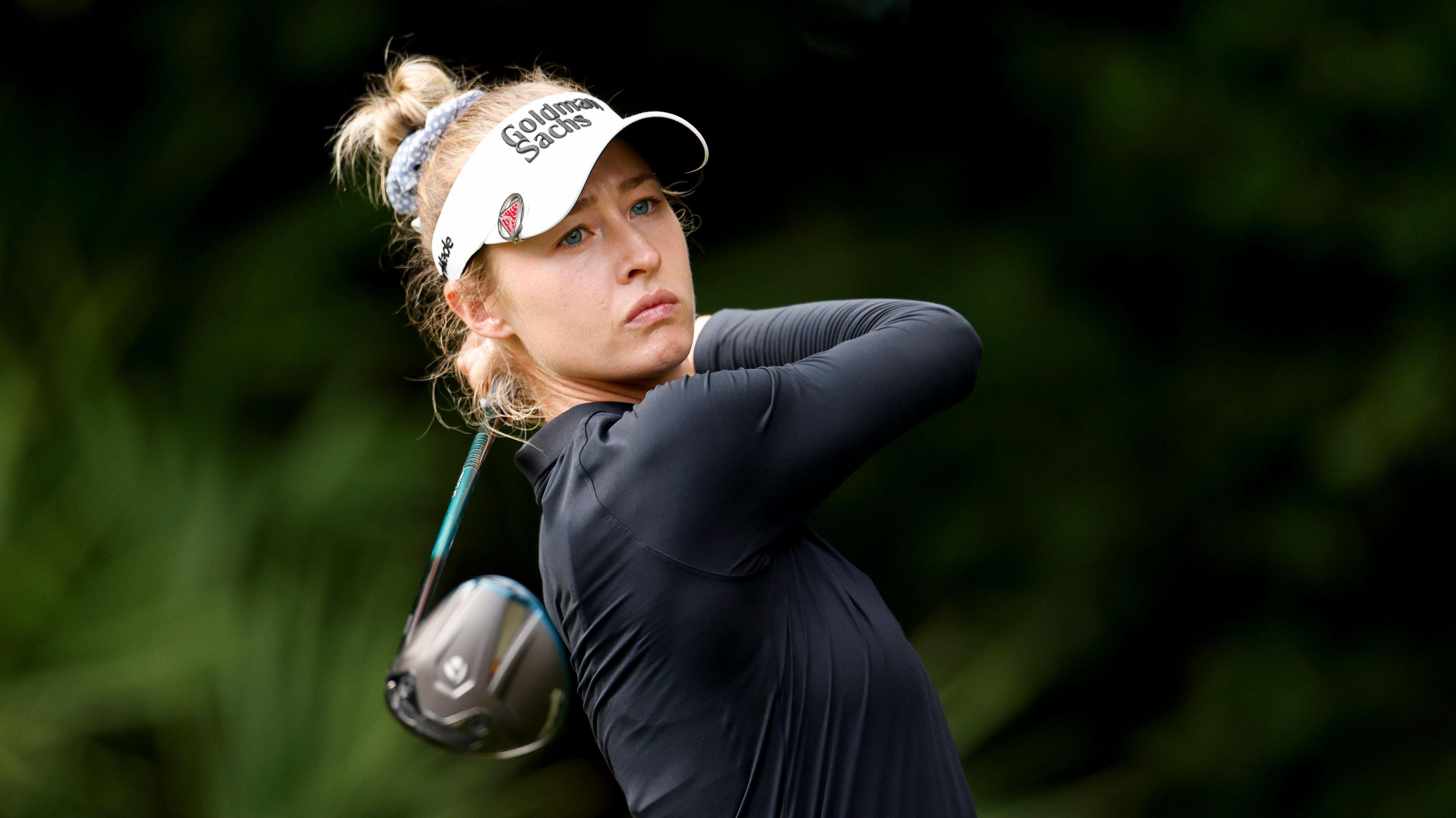 Nelly Korda looks down the course at the end of the follow-through from a shot