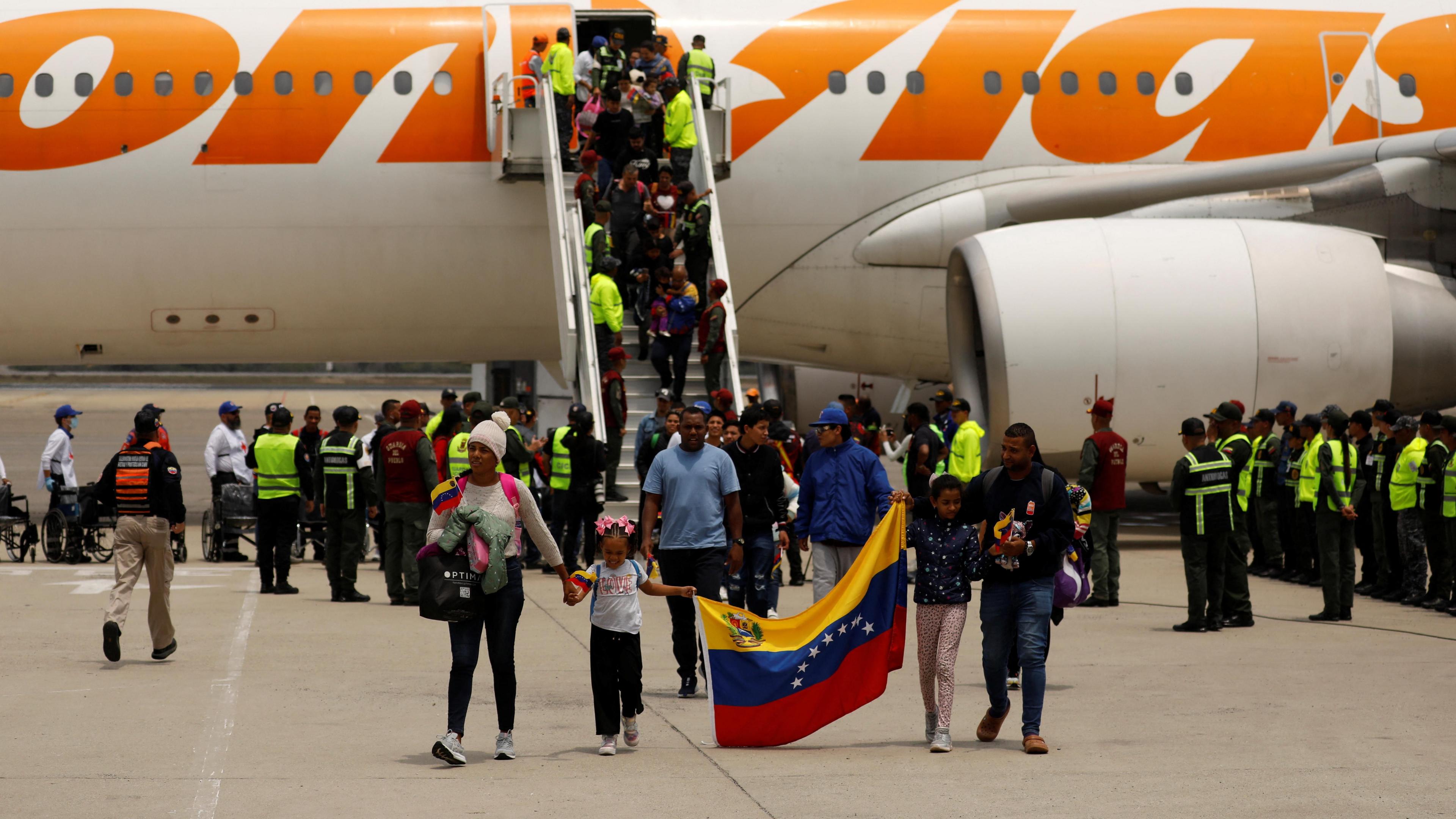 Venezuelan migrants disembark an airplane as they arrive on a repatriation flight from Mexico at the Simon Bolivar International Airport, in Maiquetia, Venezuela on 20 March