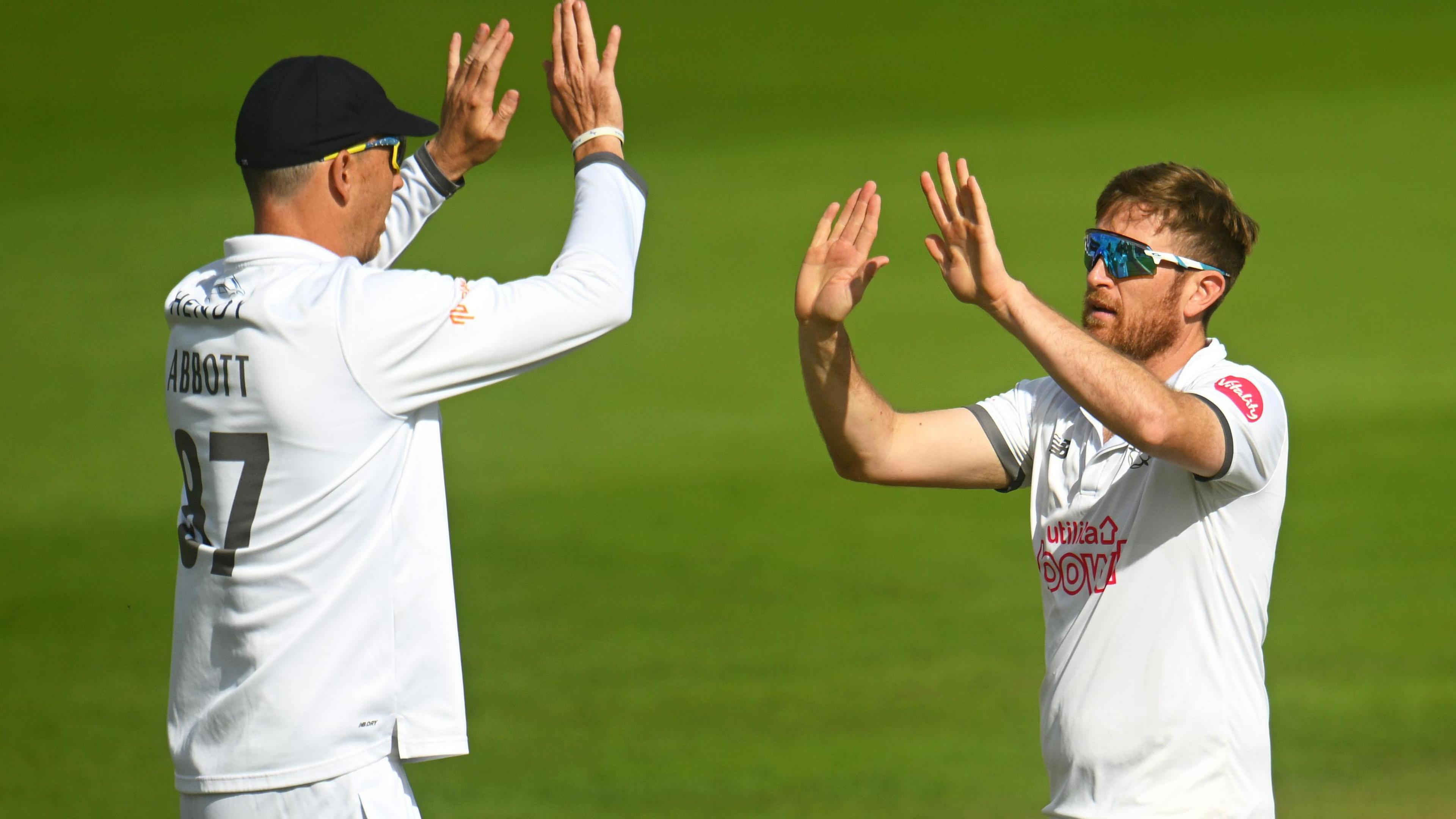 Hampshire all-rounder Liam Dawson celebrates with teammate Kyle Abbott.