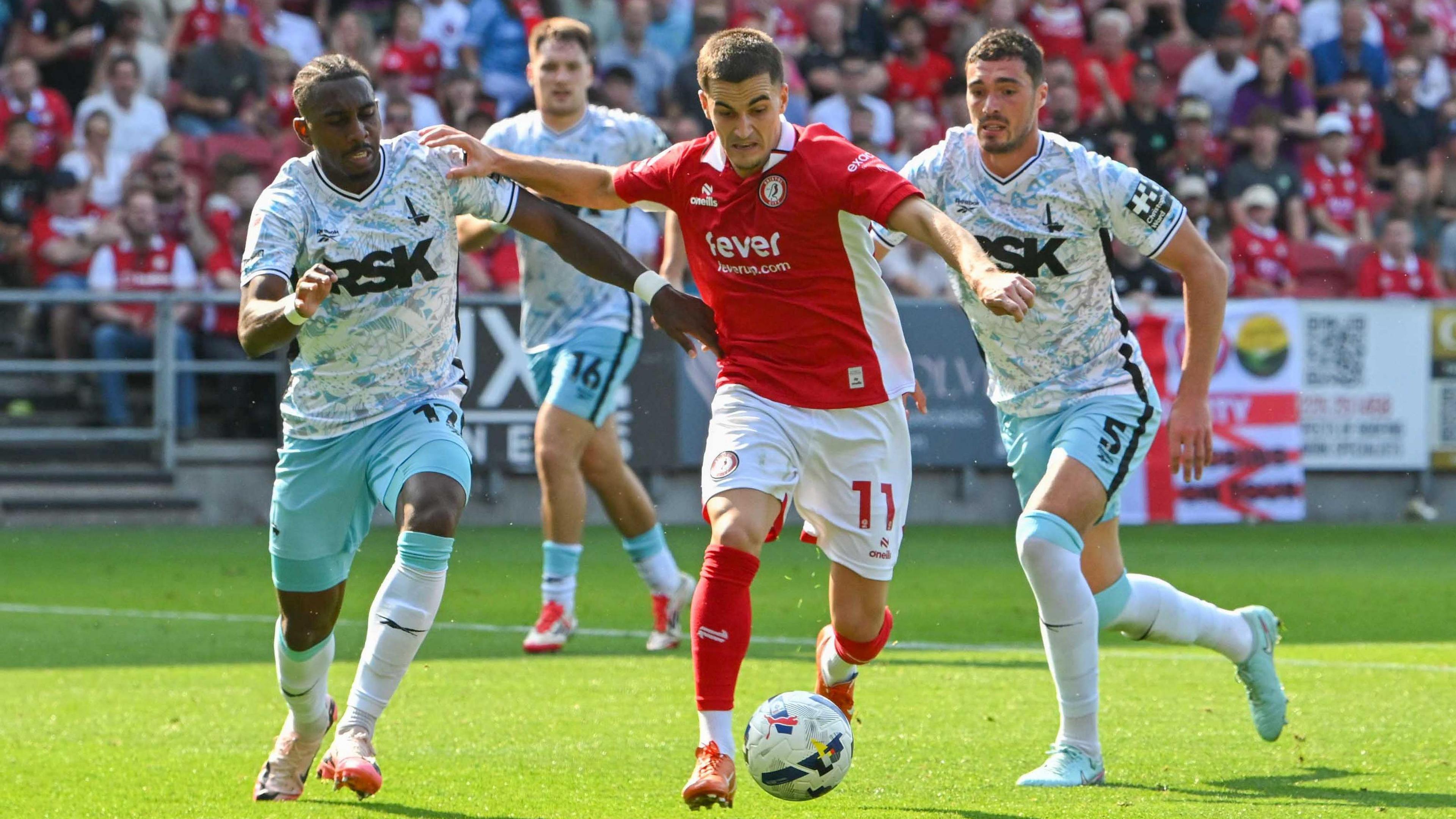 Anis Mehmeti of Bristol City on the attack battles for possession as he takes on Charlton Athletic defenders