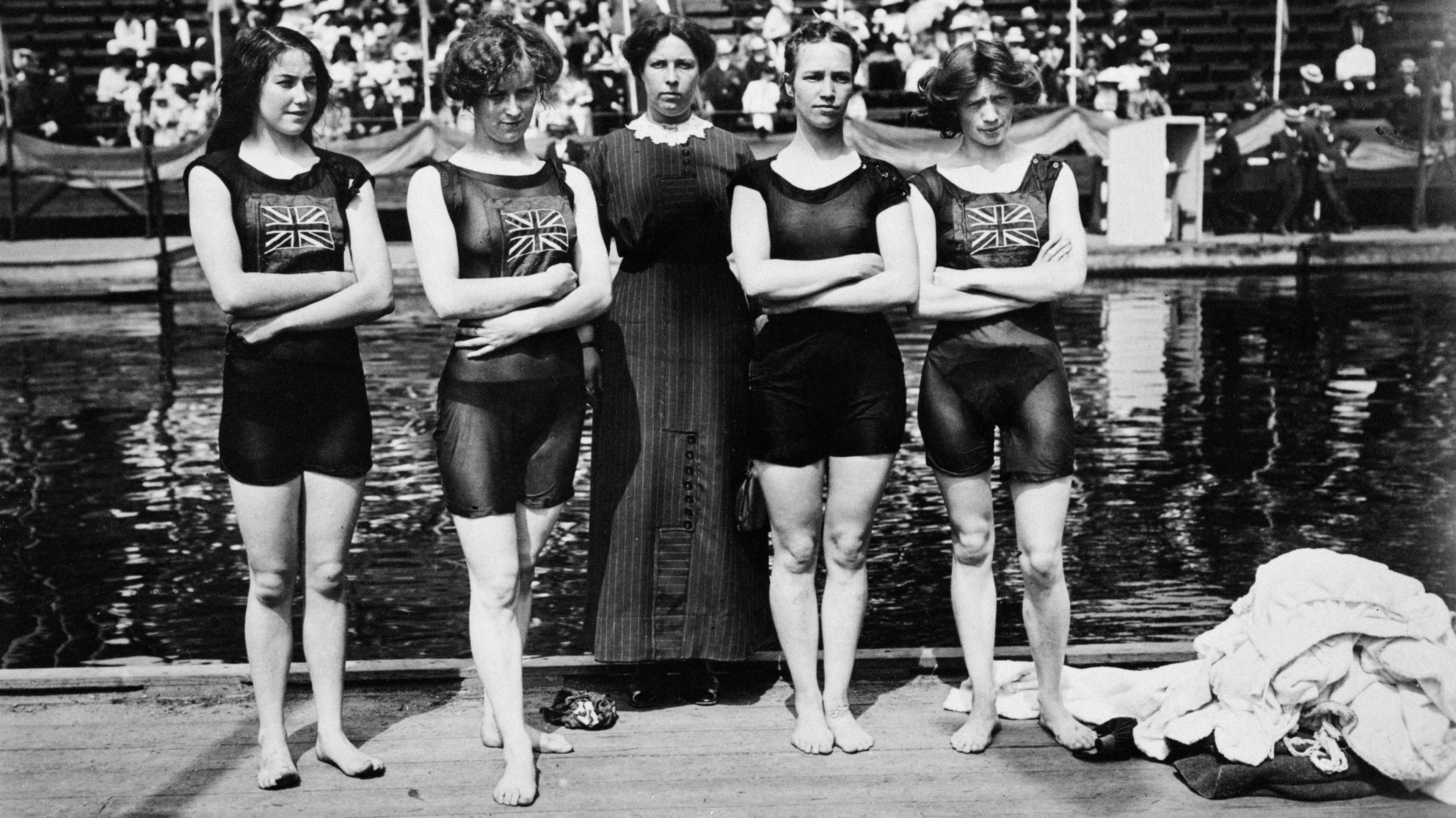 In the 4x100 metres freestyle relay final on 15 July, 2012, Irene was the anchor (last swimmer) in the British quartet. They won gold in a world record time of 5mins 52.8sec. The winners’ photo shows, left to right: Belle Moore, Jennie Fletcher, Annie Spiers and Irene Steer, with their chaperone Madame Jarvis. All four women wear swimming costumes which come down to their thigh. Three of the swimmers have the Union flag on their costumes. A large pool can be seen behind them, along with a pile of towels on the floor to the right of them. 

