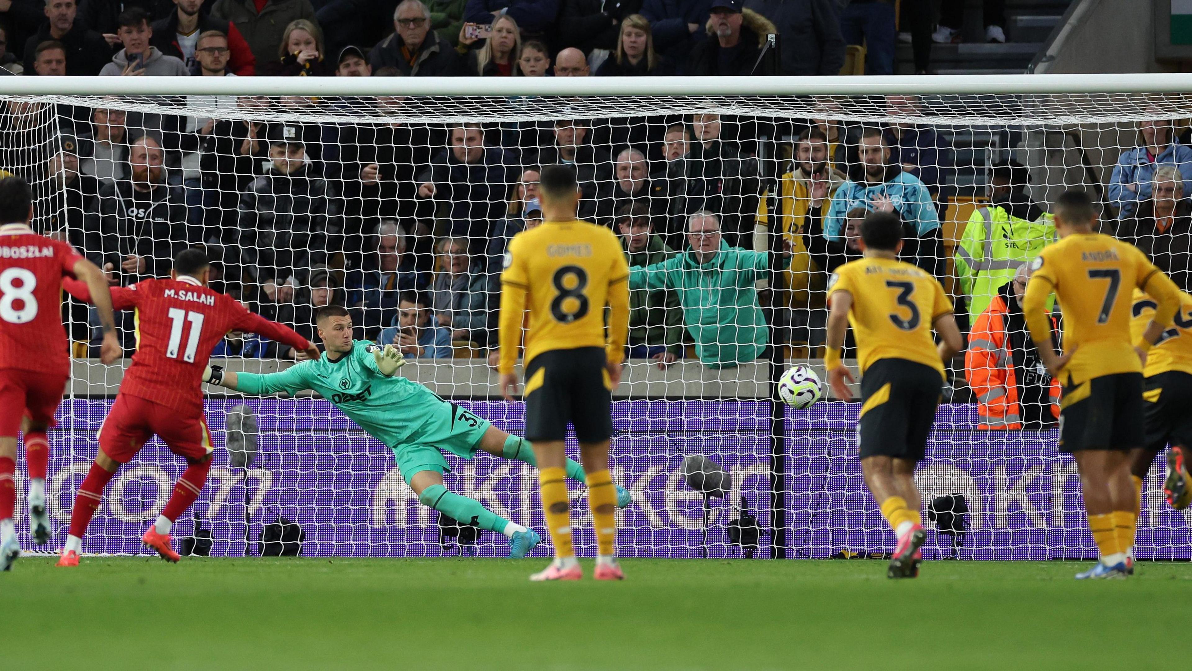 Mo Salah takes his penalty at Molineux with the picture taken from behind the area. 