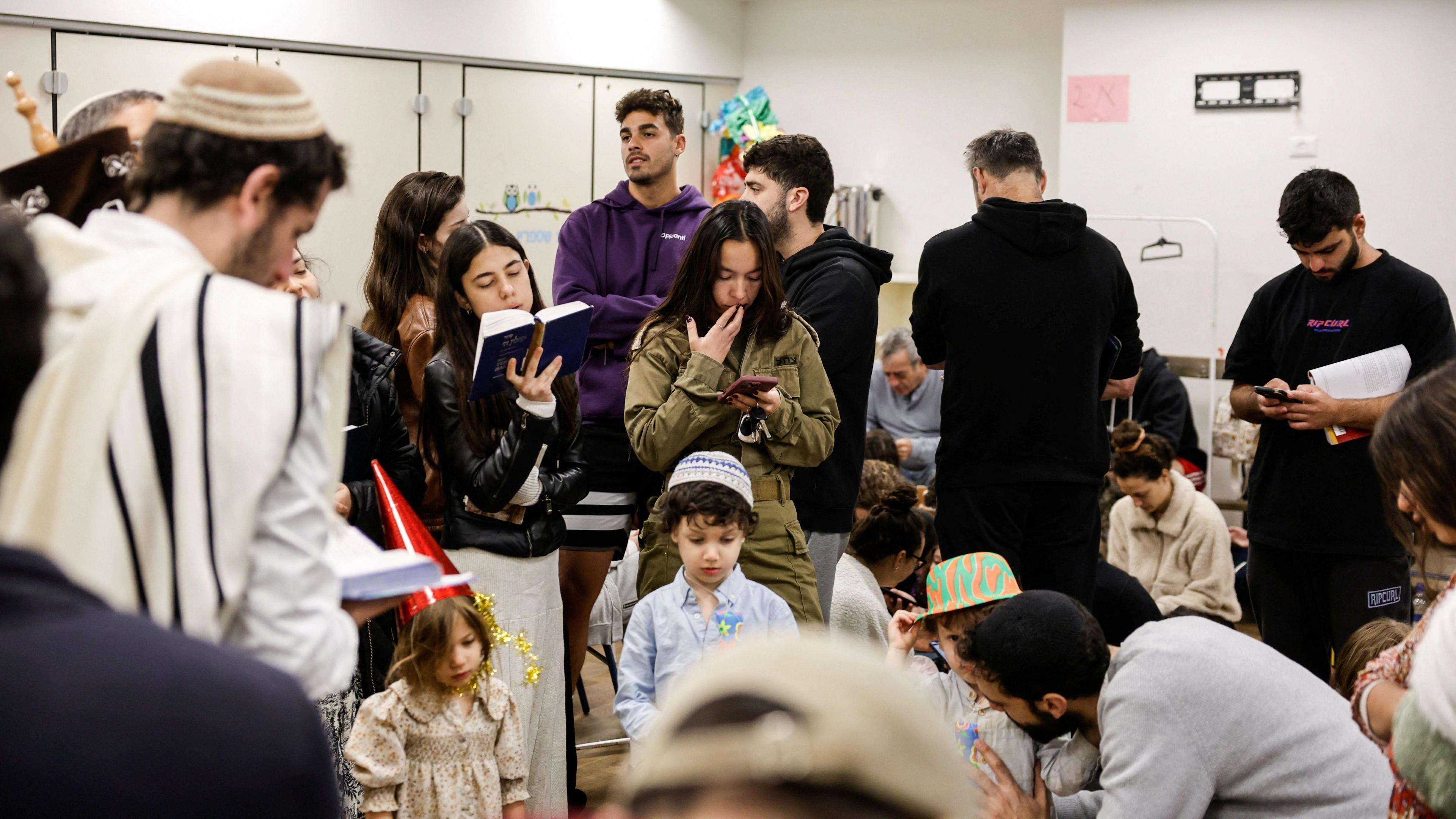 Israelis gather in a bomb shelter in Tel Aviv for safety 