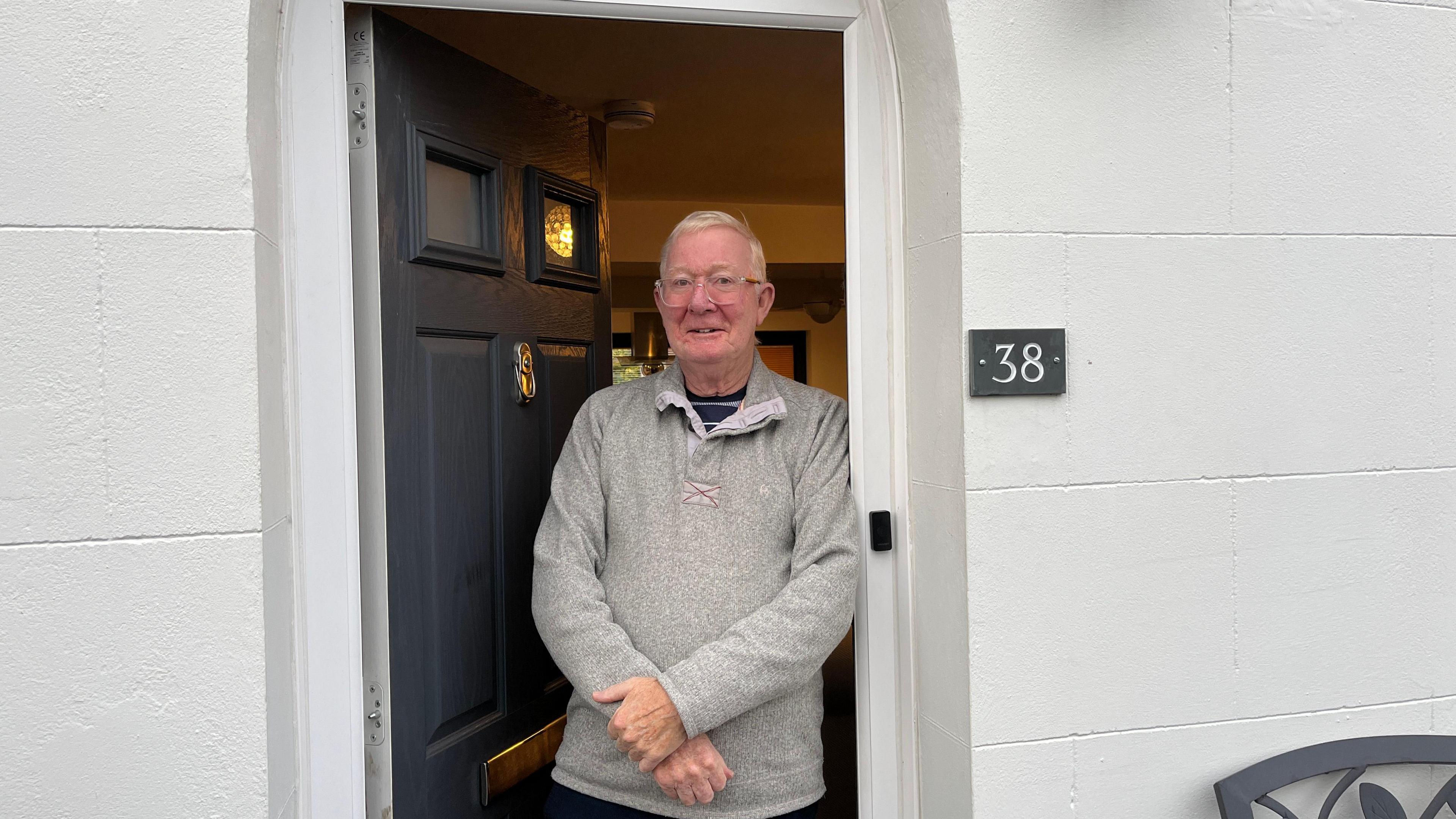 A man stood in his doorway