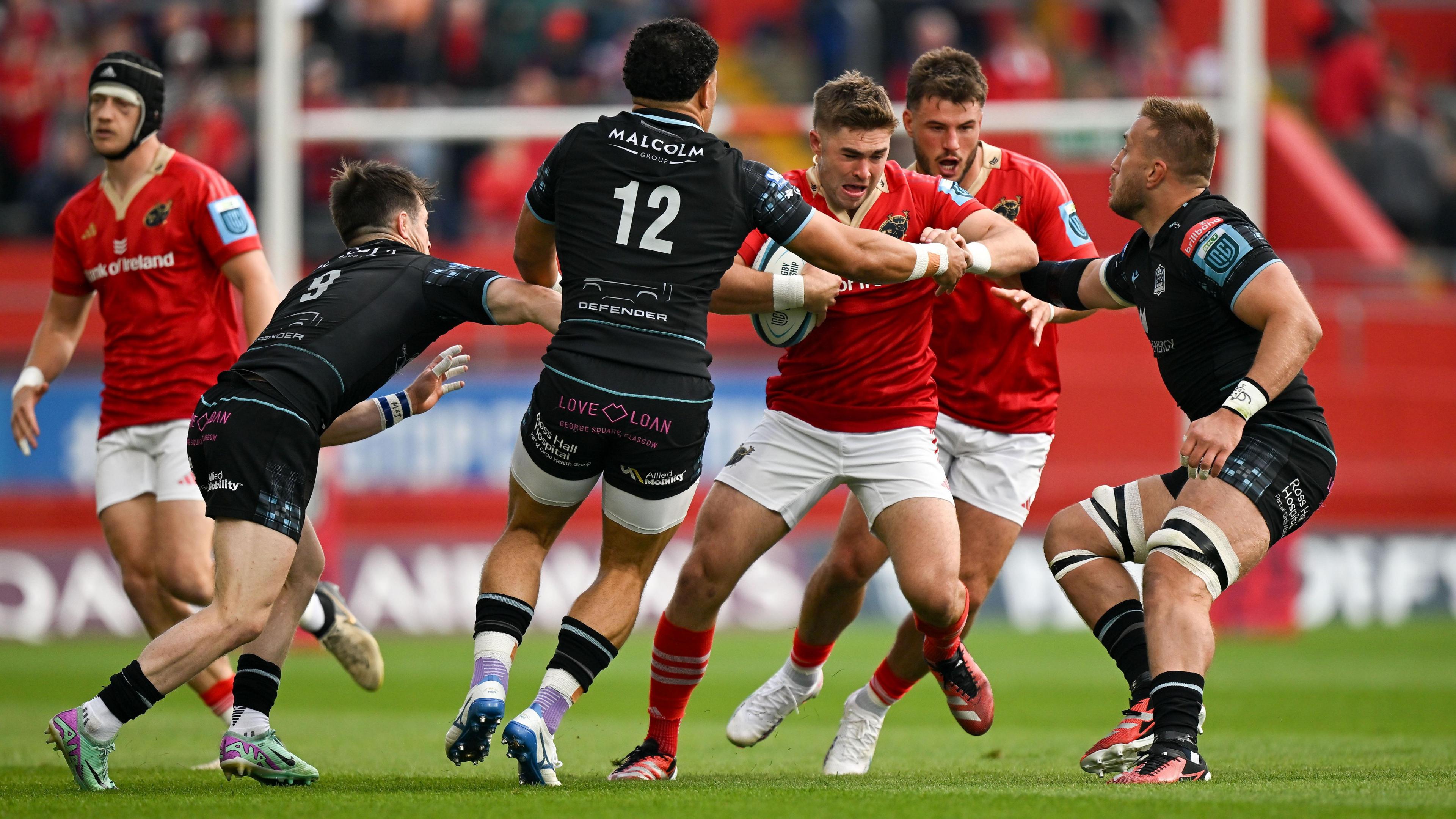 Glasgow's Sione Tuipulotu tackles Jack Crowley of Munster.