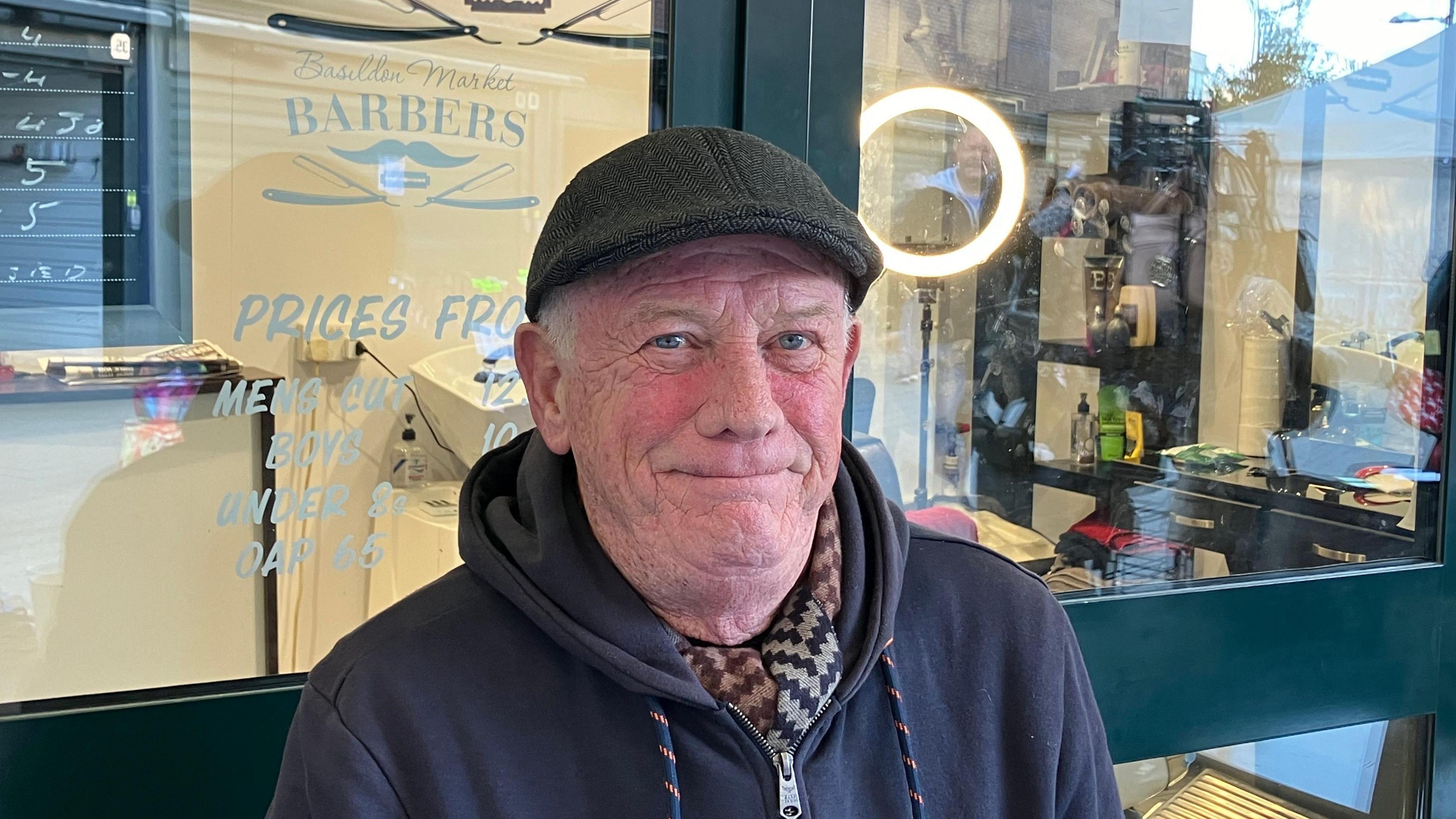 A head and shoulders picture of Seamus Murray outside his barber shop on Basildon Market