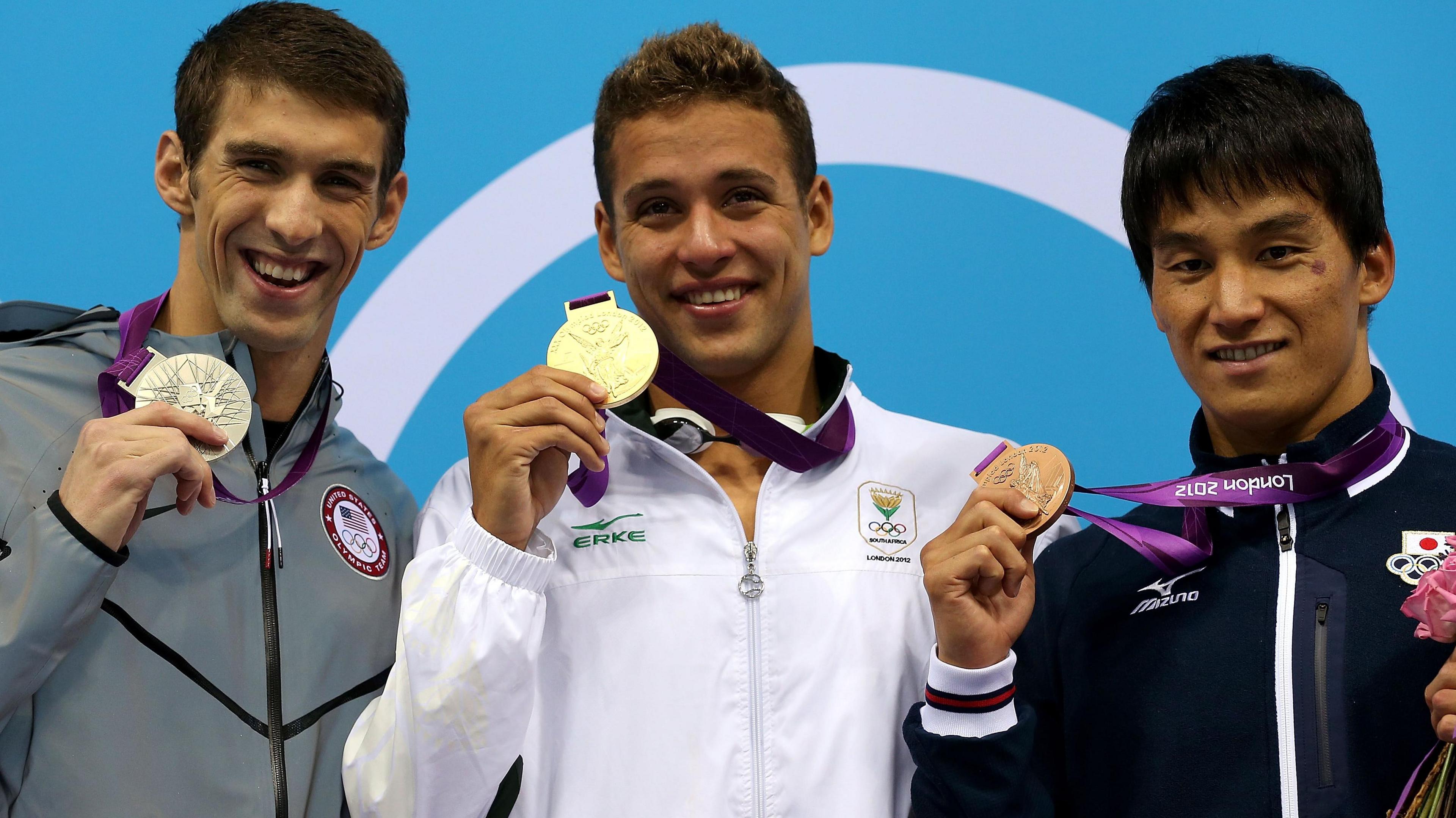 Silver medallist Michael Phelps of the United States, gold medallist Chad le Clos of South Africa and bronze medallist Takeshi Matsuda of Japan pose on the podium during the medal ceremony for the Men's 200m Butterfly final at London 2012