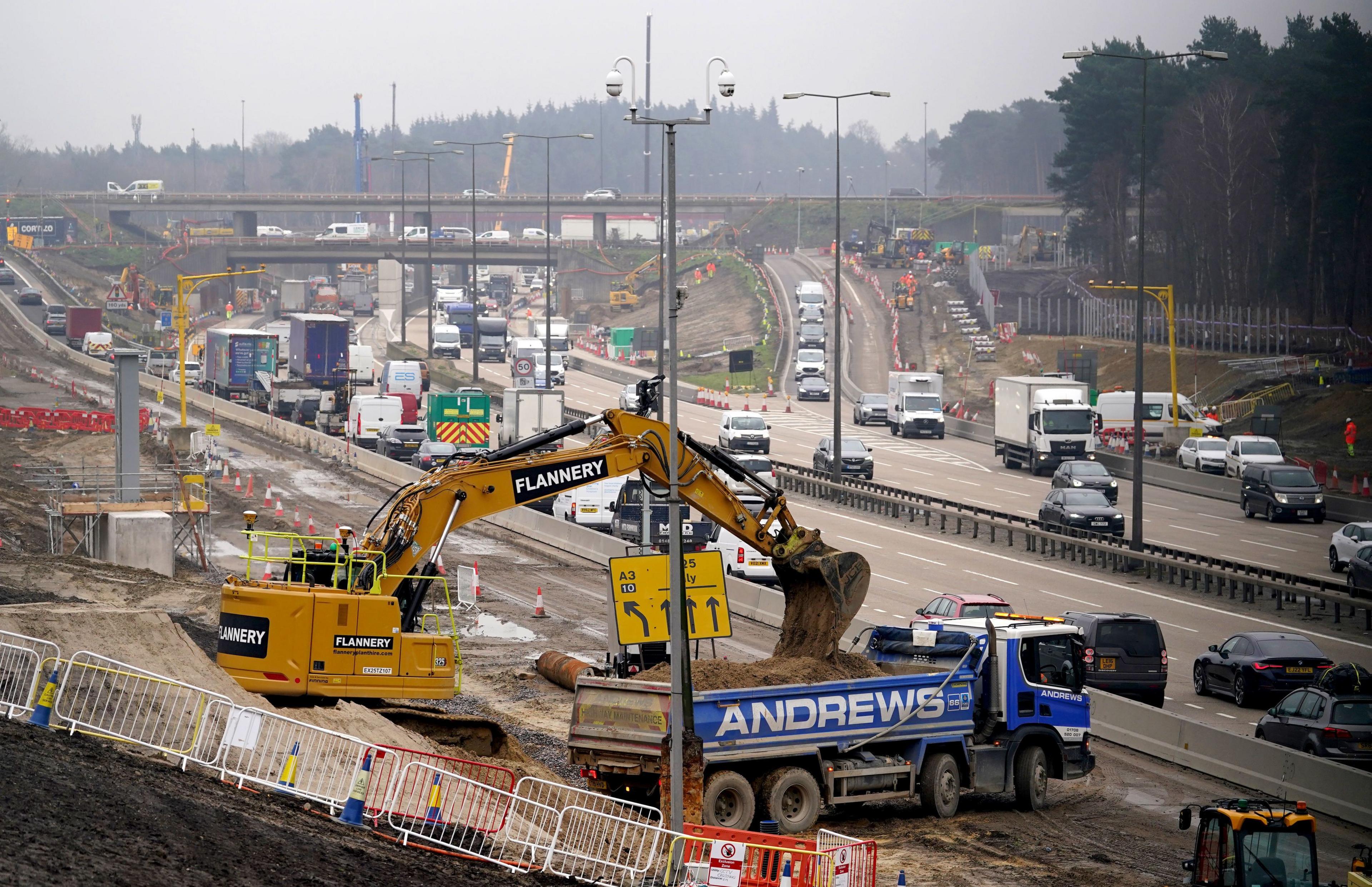 Roadworks with a yellow digger in the foreground