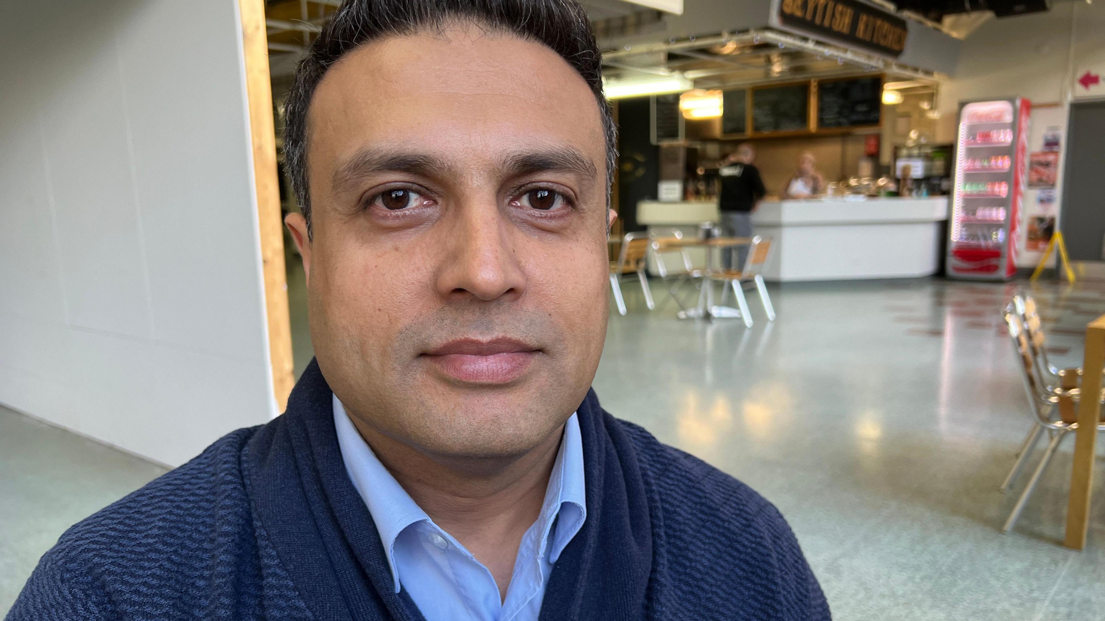 New owner Tahir Ali in a cafe in the old market hall