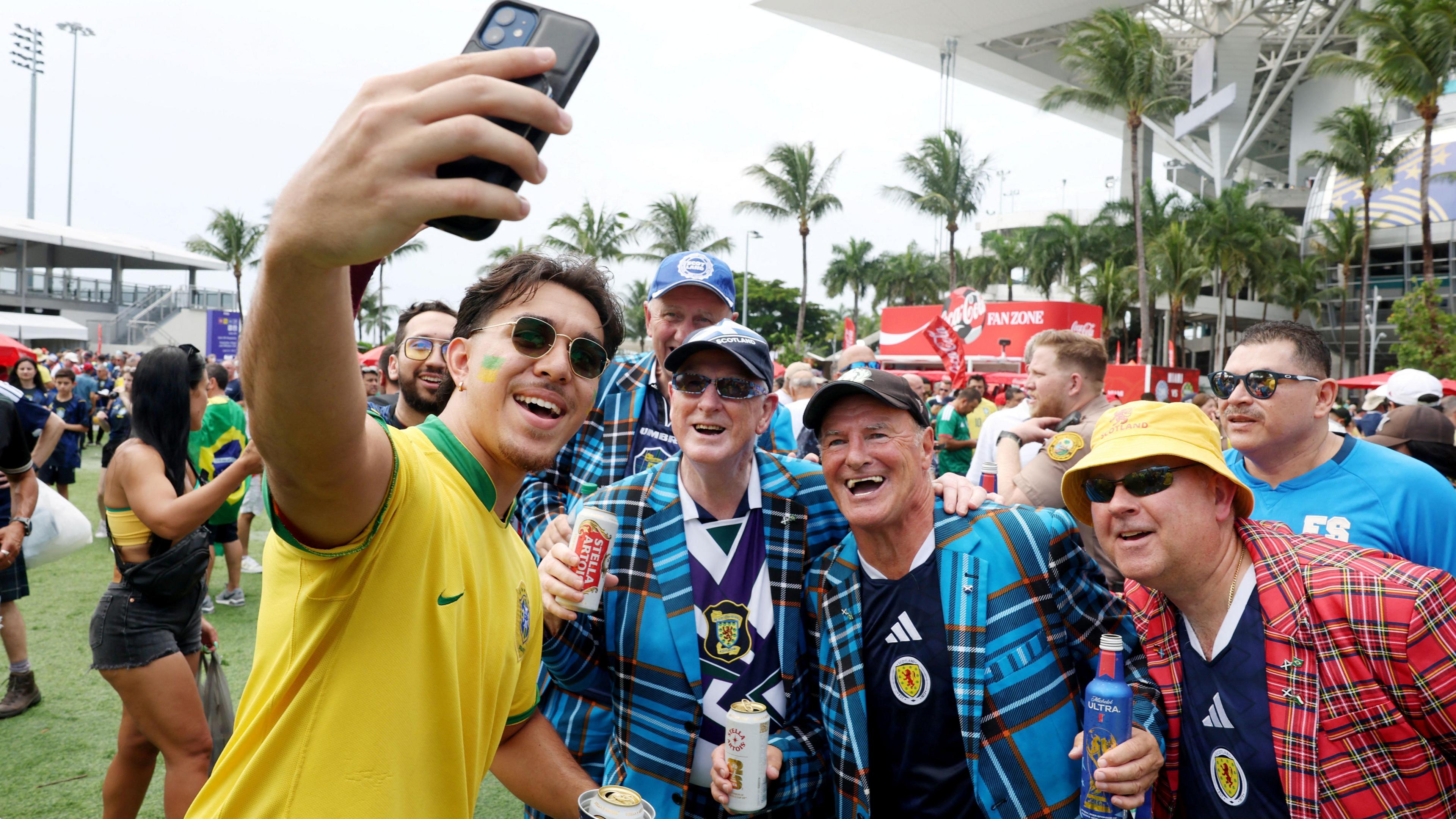 Soccer Football - FIFA World Cup 2026 - Group C - Scotland v Brazil - Miami Stadium, Miami Gardens, Florida, U.S. - June 24, 2026
A Brazil fan takes a selfie with Scotland fans outside the stadium before the match REUTERS/Paul Childs