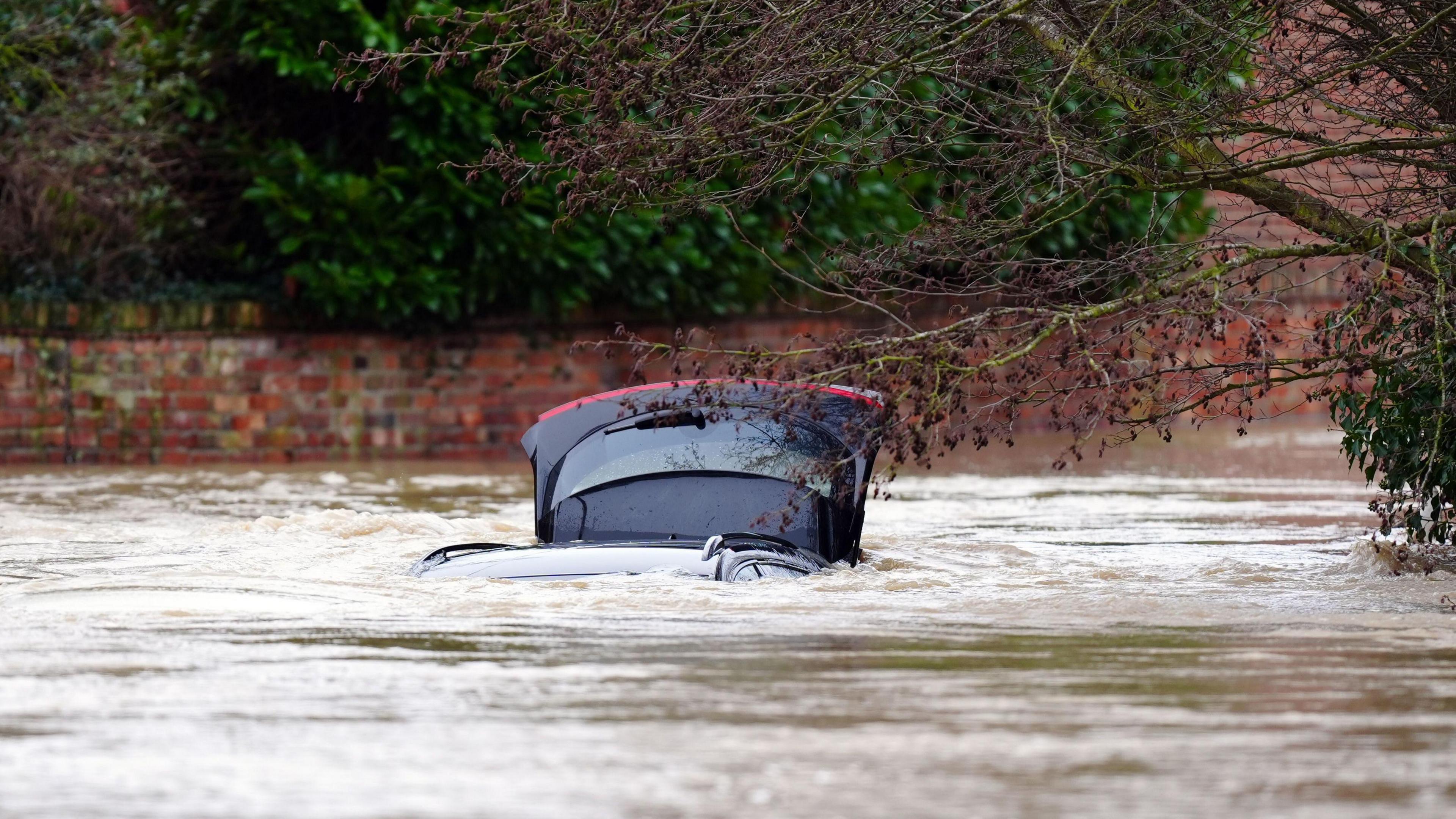 A vehicle is submerged under water near the River Devon, in Bottesford, Leicestershire. 