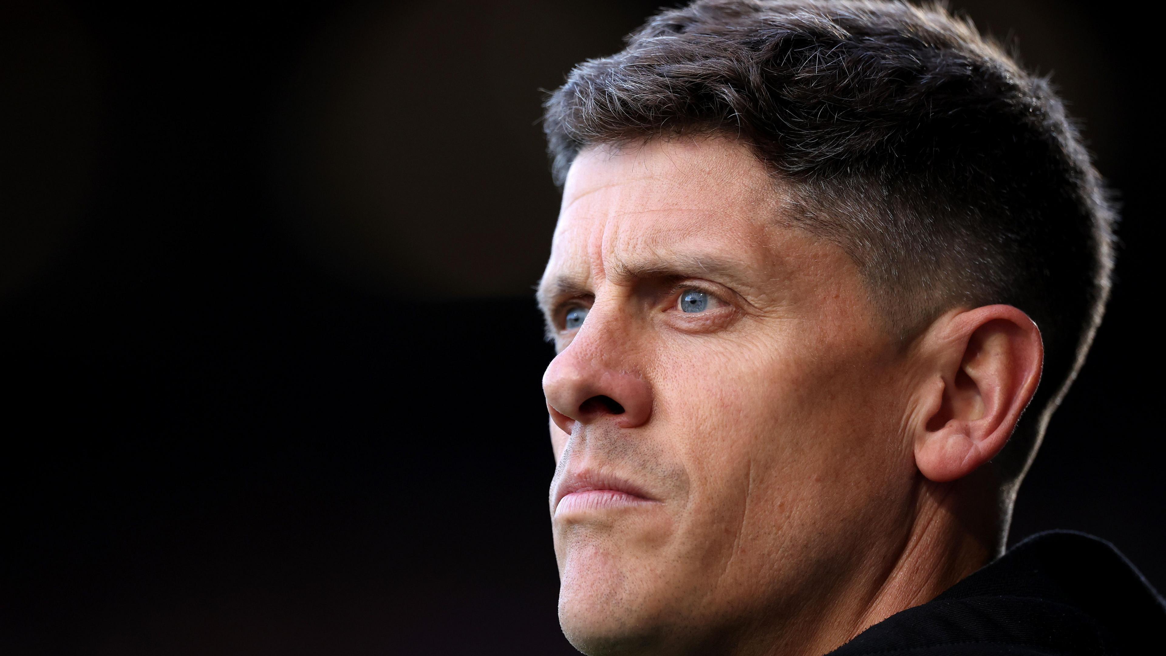 A close-up of Alex Revell in front of a black background