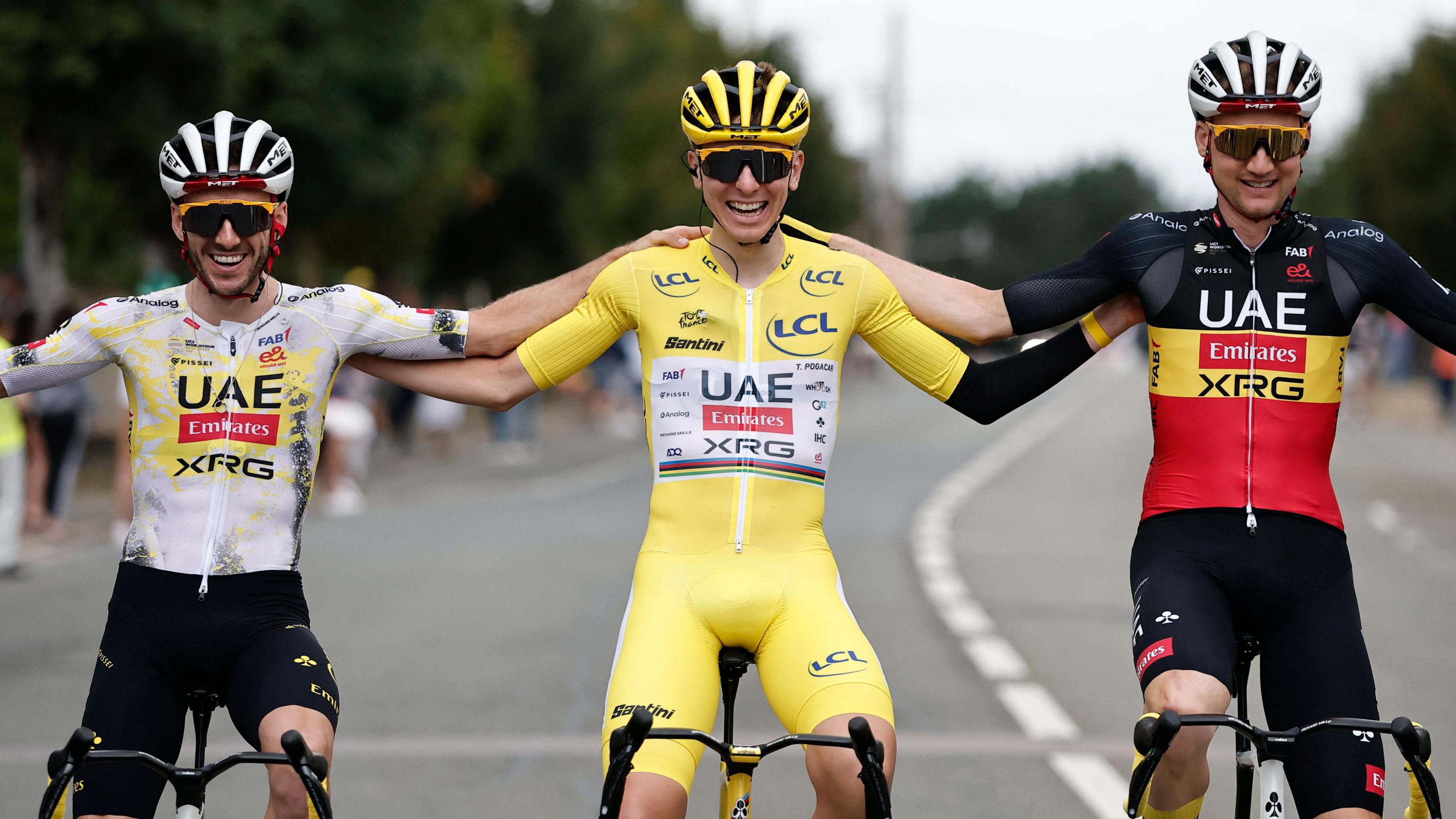 UAE Team Emirates-XRG team-mates Adam Yates, Tadej Pogacar and Tim Wellens pose for a picture during the final stage of the 2025 Tour de France