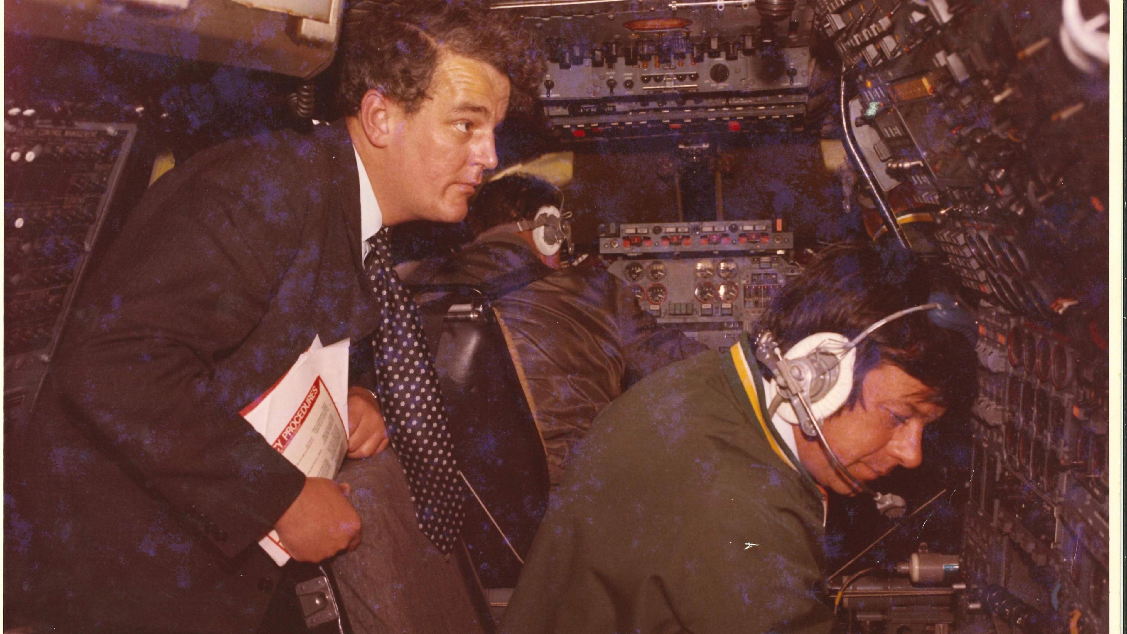 Photo from 1969 showing Brian Watts scrutinising the flight deck in front of the pilot on the first Concorde flight