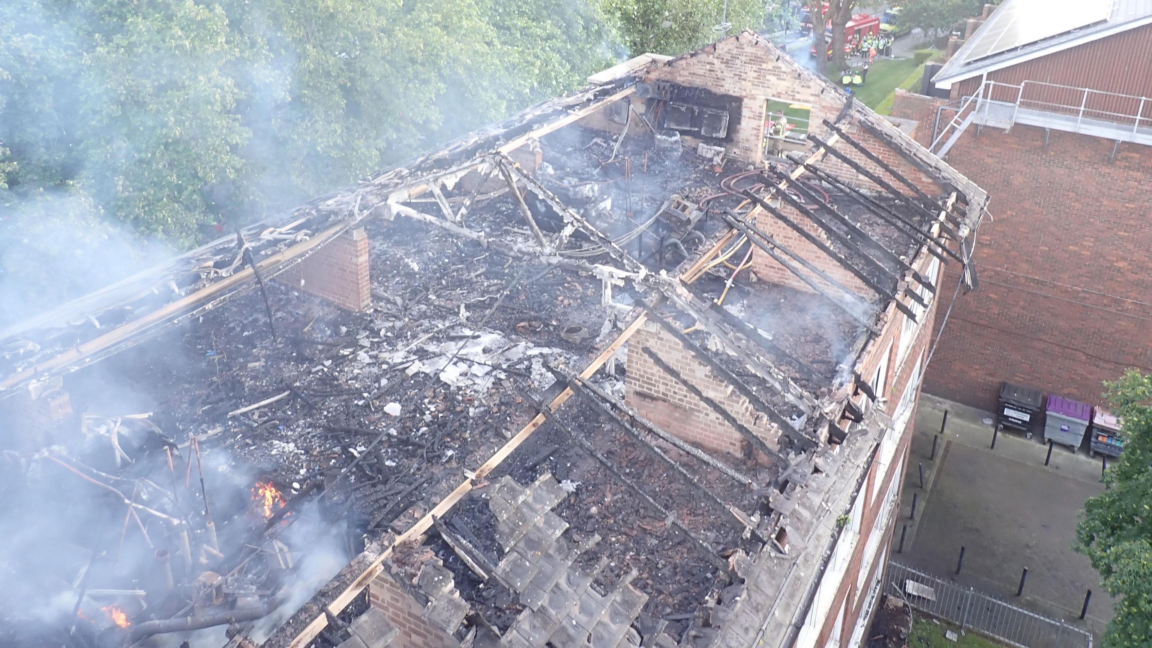 Burnt out roof of Dalston Lane flats